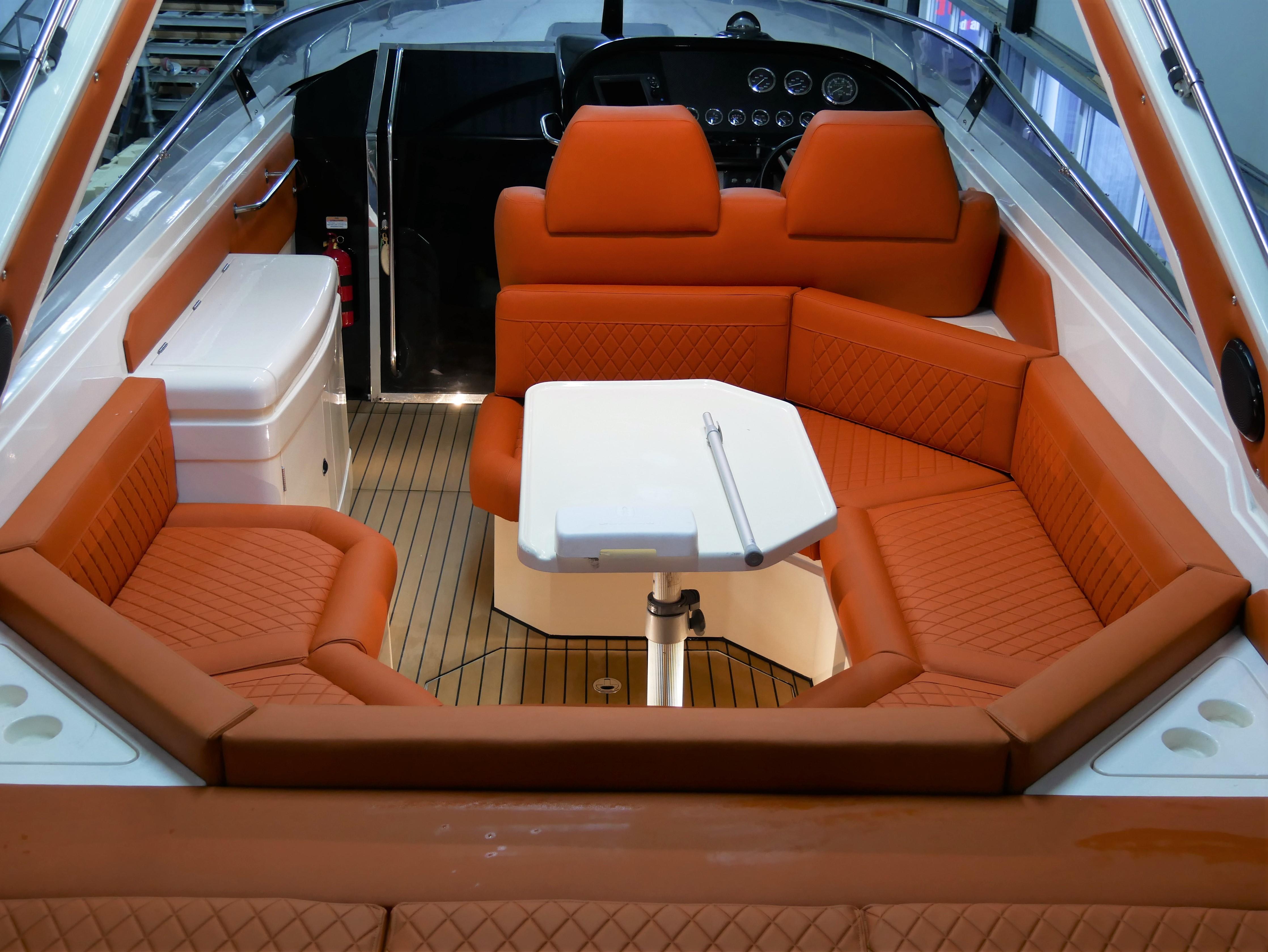 Interior of 1991 Sunseeker Thunderhawk 43 with orange seating and white table.