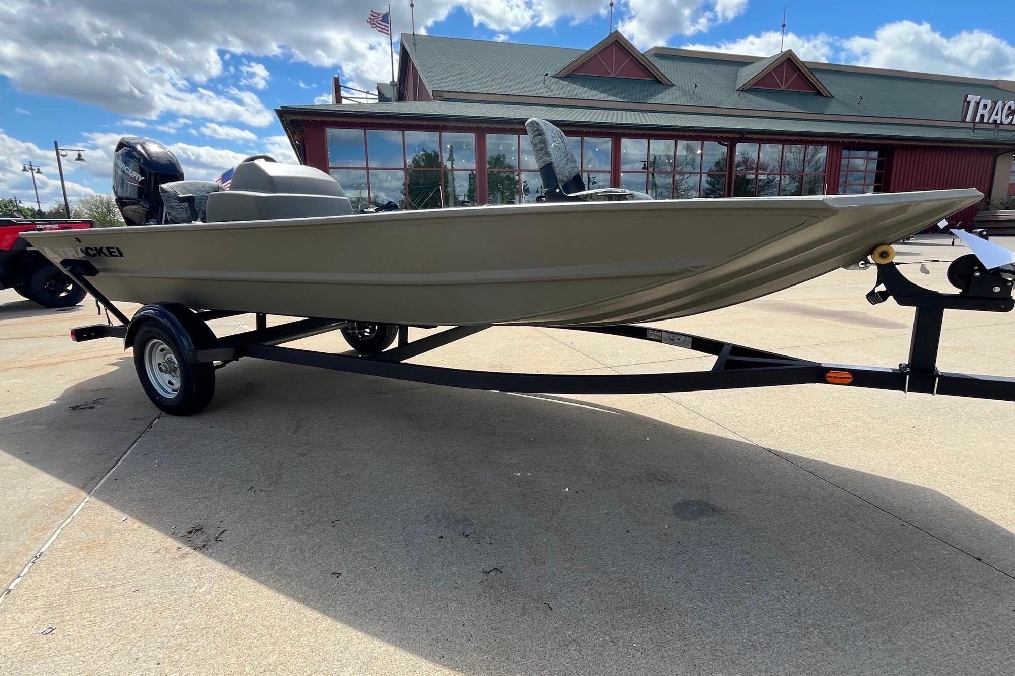 2026 Tracker Grizzly 1754 SC boat on trailer, parked outdoors under a cloudy sky.