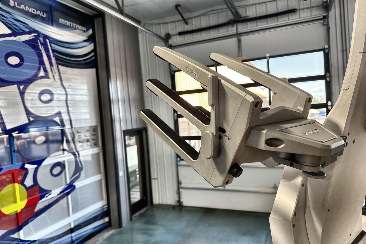 Robotic arm in a modern garage, featuring a 2020 Supra SE.