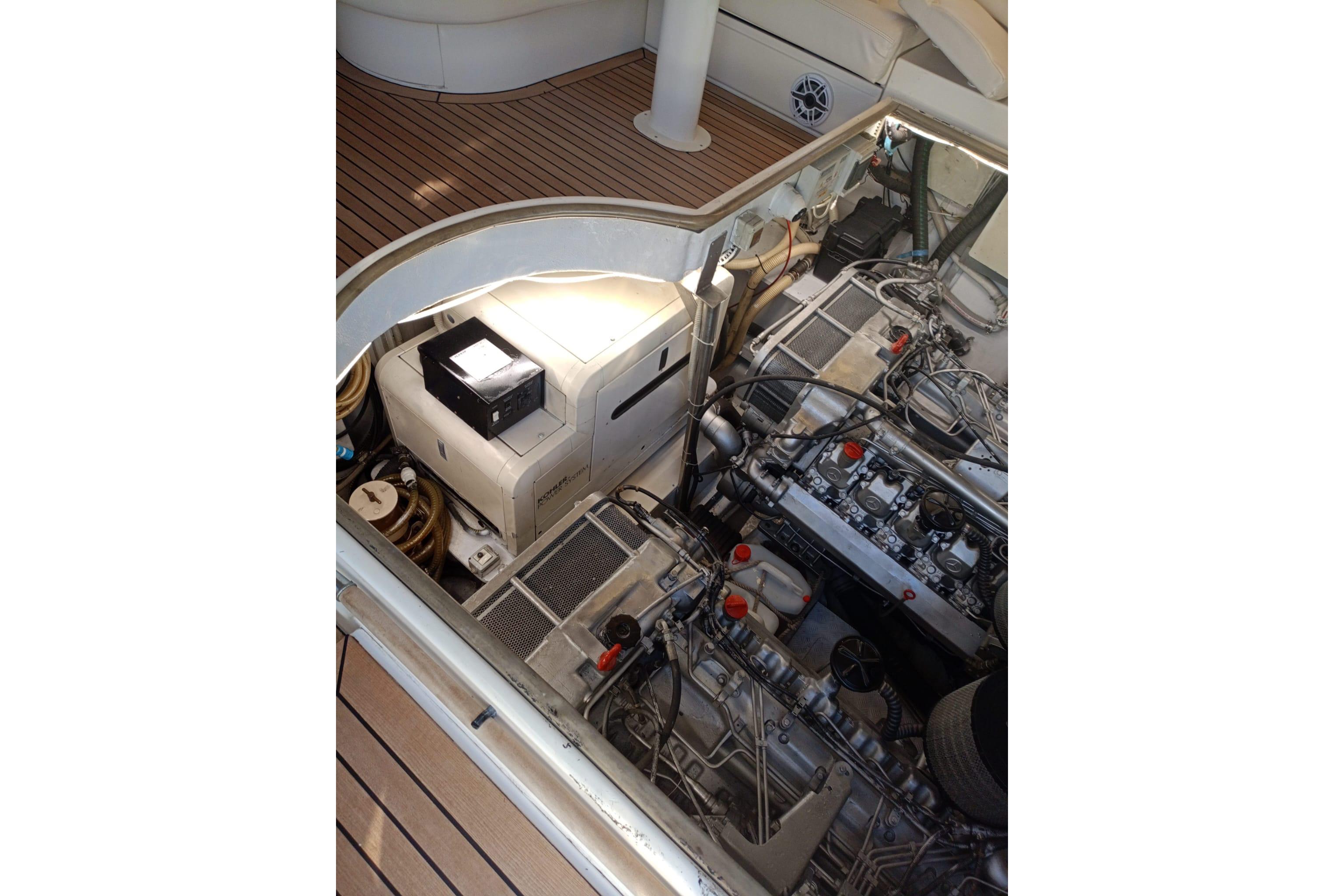 Engine room of 2001 Baia Azzurra 63 yacht, showcasing mechanical components and equipment.