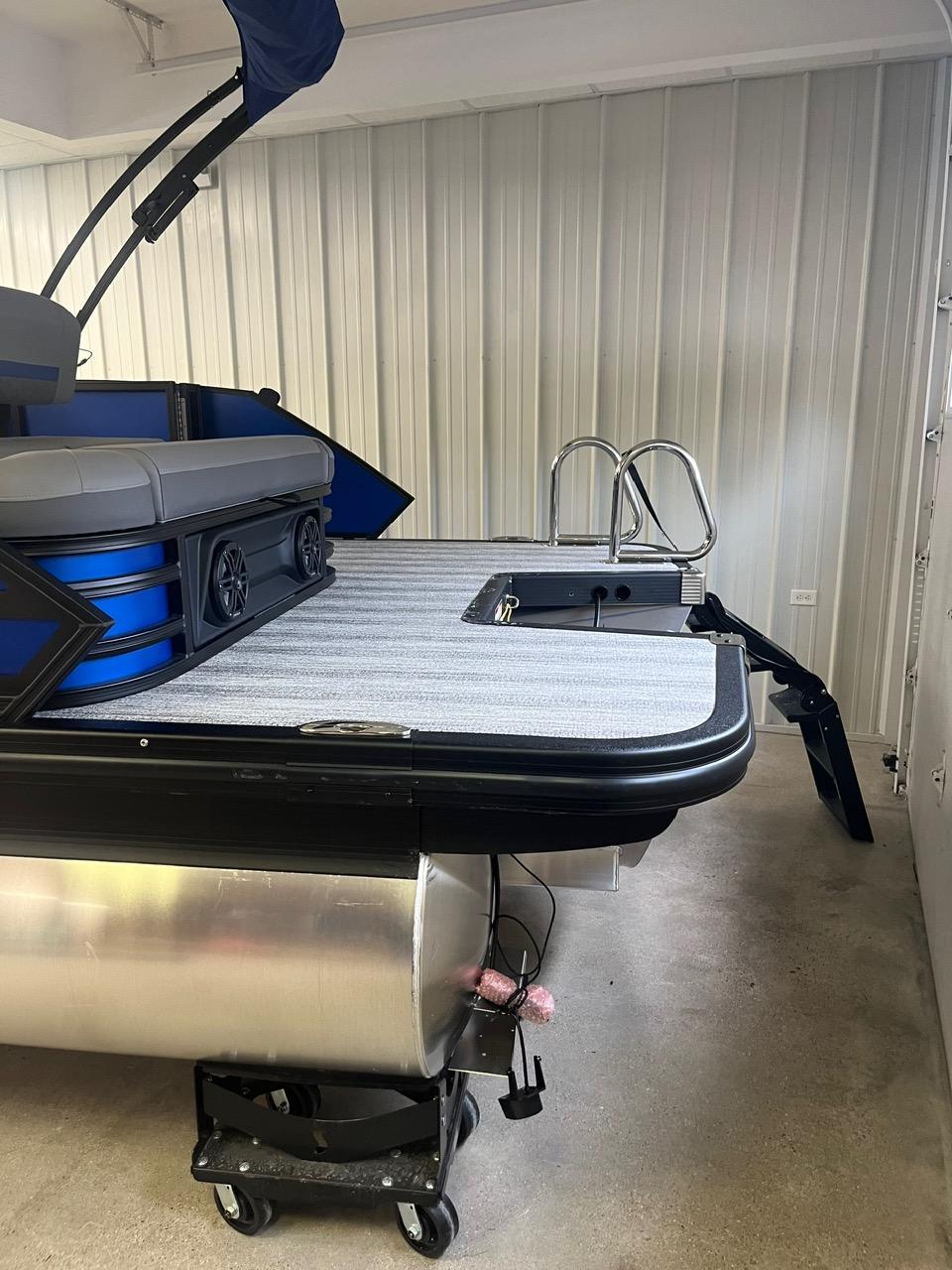 2025 Bennington 24 MSB pontoon boat in storage, featuring sleek design and modern amenities.