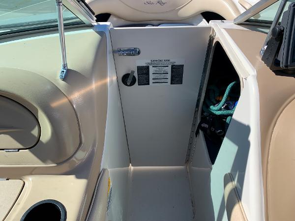 Interior view of a 2000 Sea Ray 210 Bow Rider boat showing storage compartment.