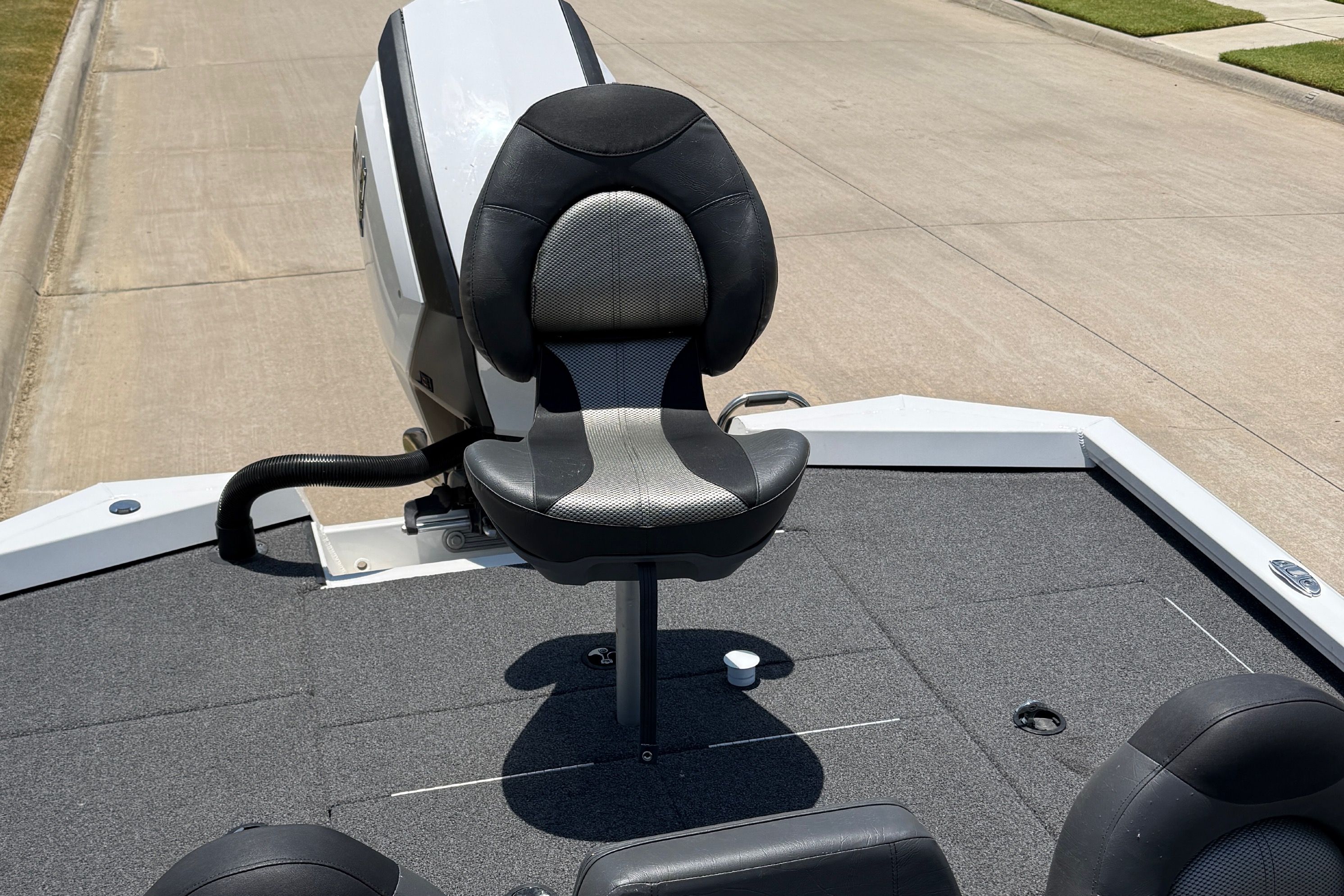 A 2019 Vexus AVX1980 with a cushioned seat on a gray deck, parked on a street.