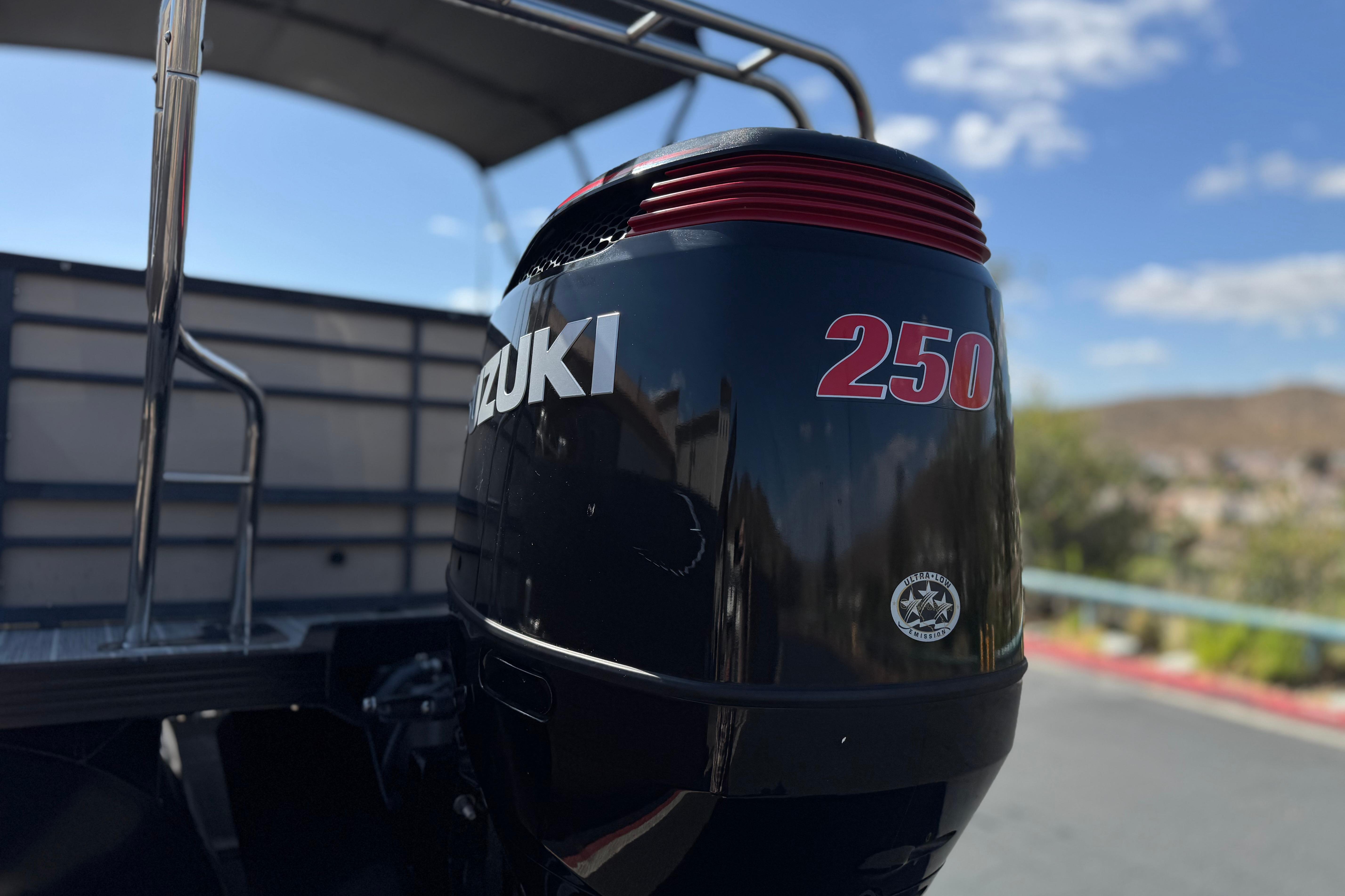 Outboard motor on 2023 Lexington 623 ST Xtreme boat under clear sky.
