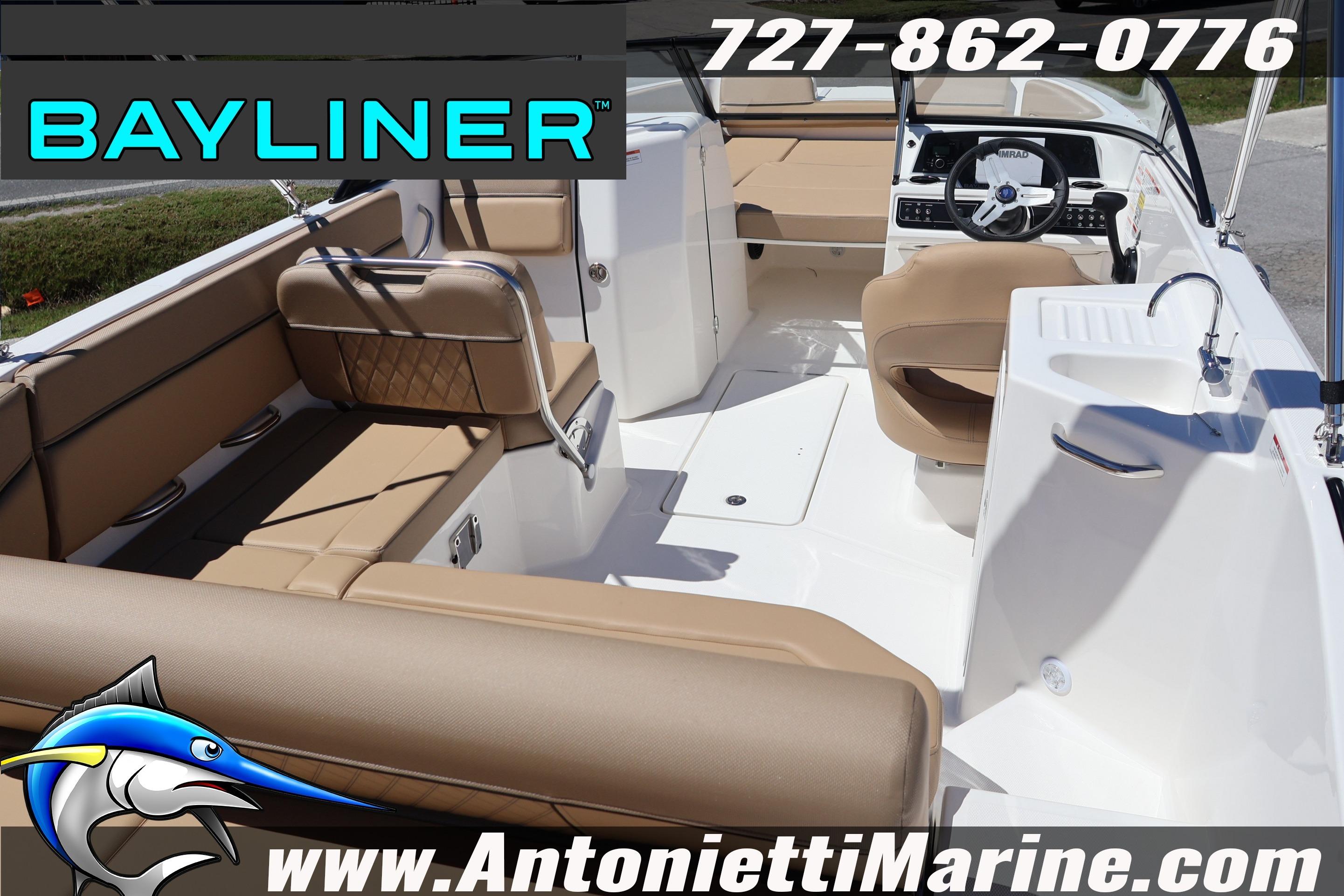 2026 Bayliner D22 boat interior with tan seating, steering wheel, and sink.