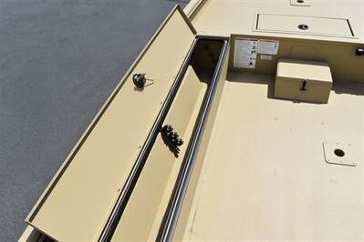 2025 Lowe Roughneck 1860 boat storage compartment, open lid, beige interior, organized layout.