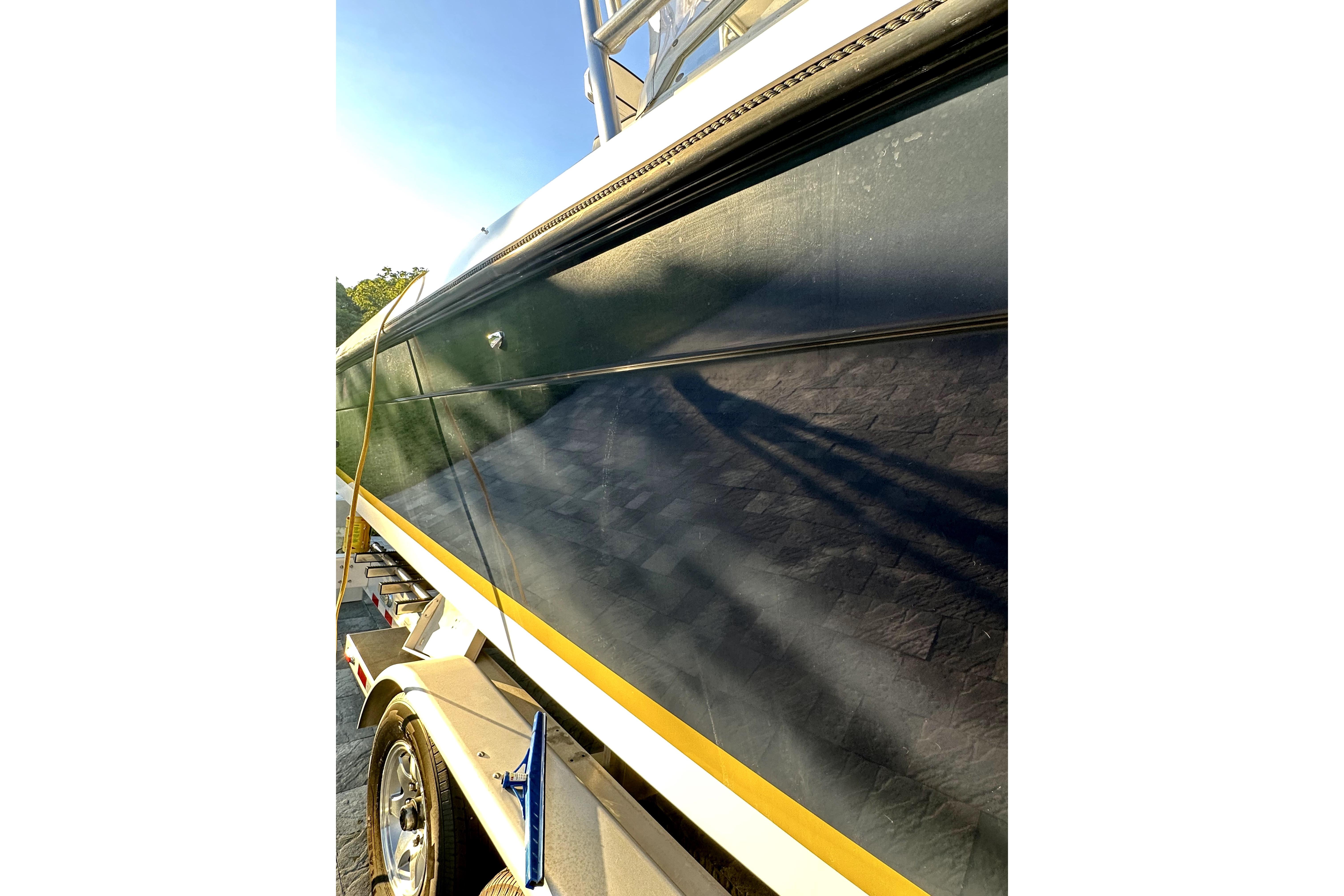 2006 Contender 35 Express Side Console boat on trailer, close-up view.