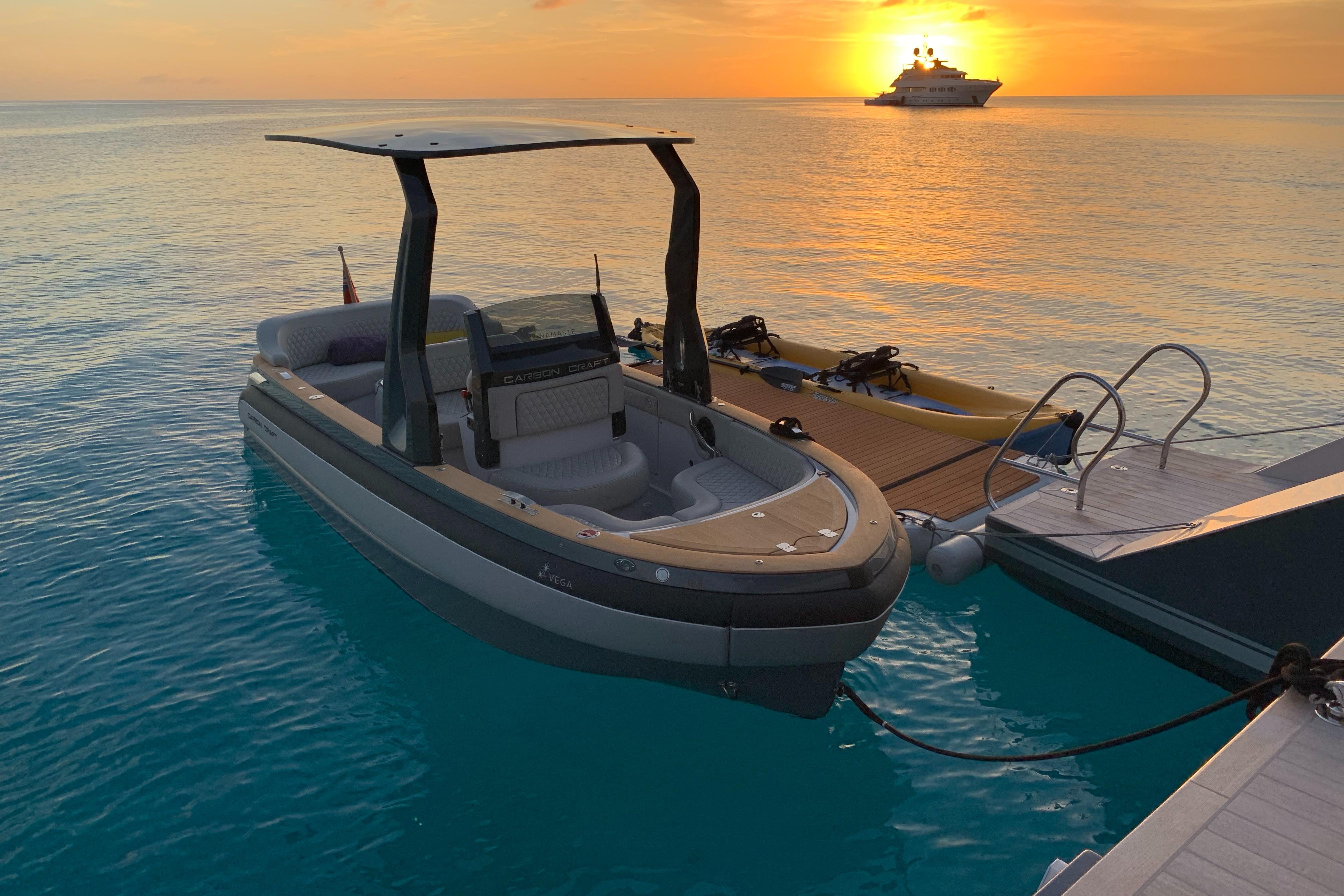 Carbon Craft CC 160 boat docked at sunset, 2016 model, with yacht in background.