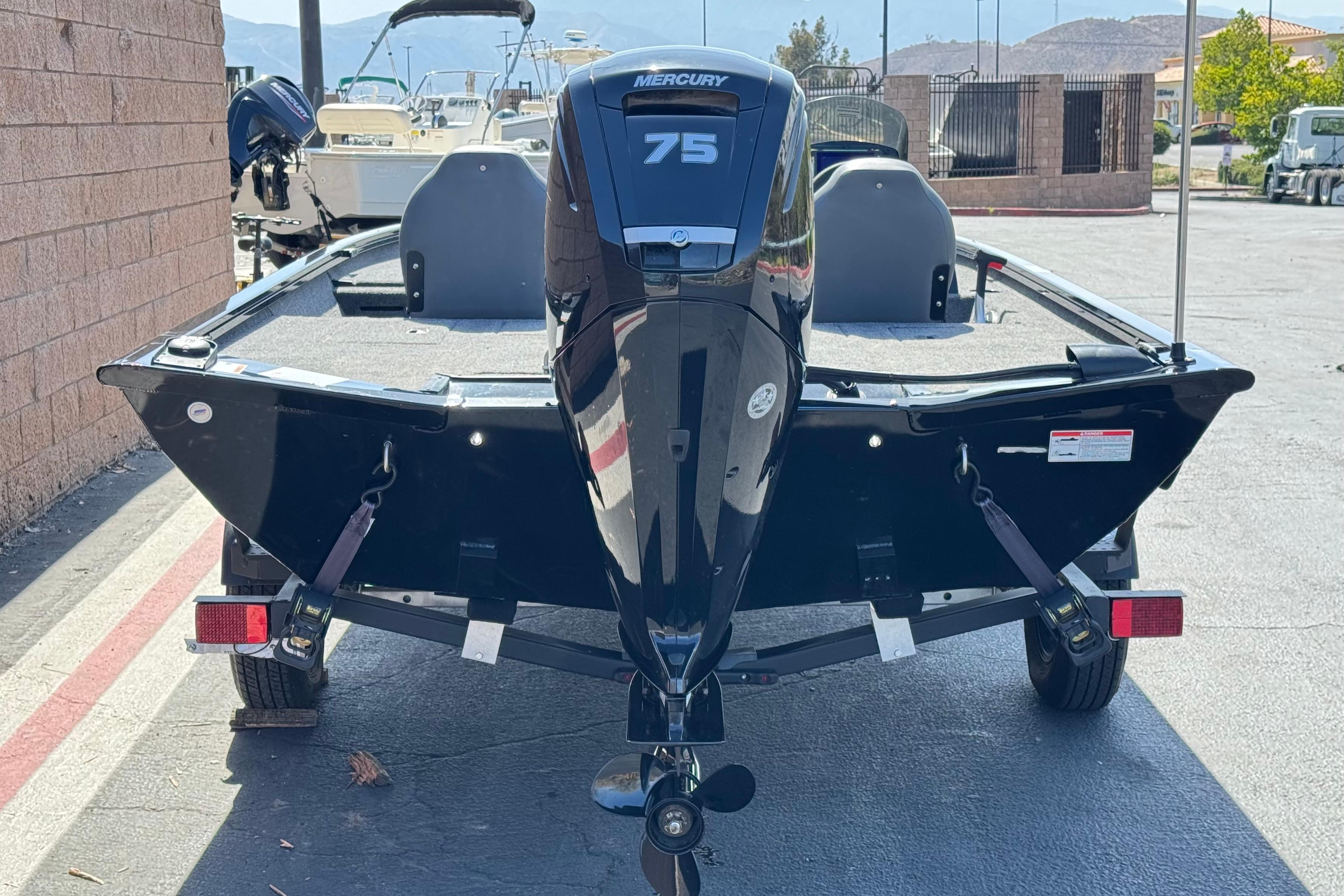 2024 Lowe Stinger 175 boat with Mercury 75 engine, parked outdoors.