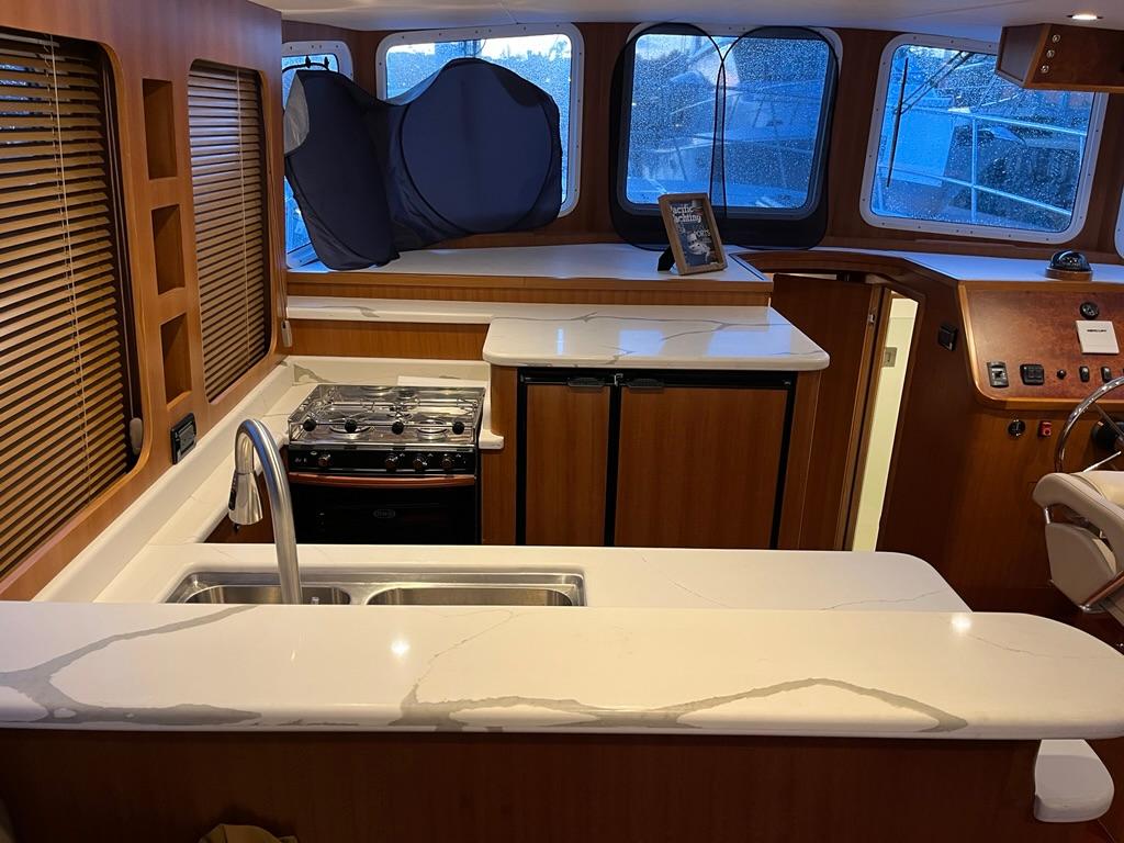 Luxurious Bracewell 41 yacht interior with modern kitchen, sleek countertops, and panoramic windows, 2025 model.