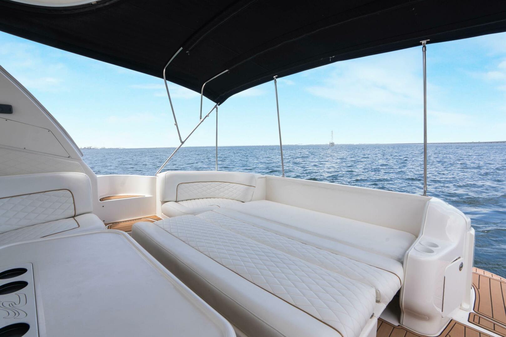 Luxurious 2003 Sea Ray Sundancer 460 yacht interior with ocean view and comfortable seating.