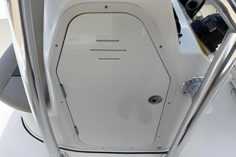 2025 Key West 210 Bay Reef boat console with storage compartment and stainless steel railing.
