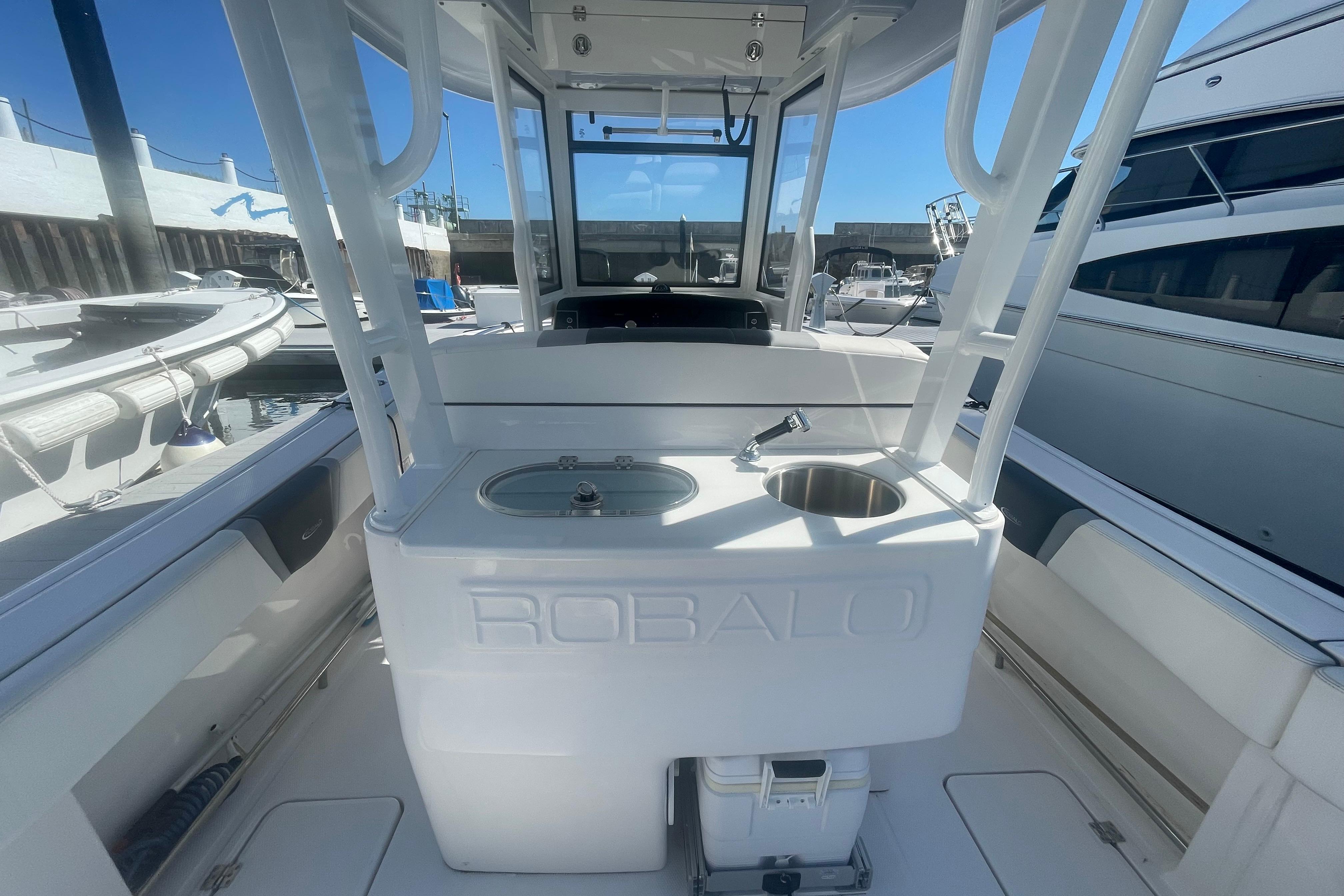 2023 Robalo R270 Center Console boat interior with sink and storage at marina.