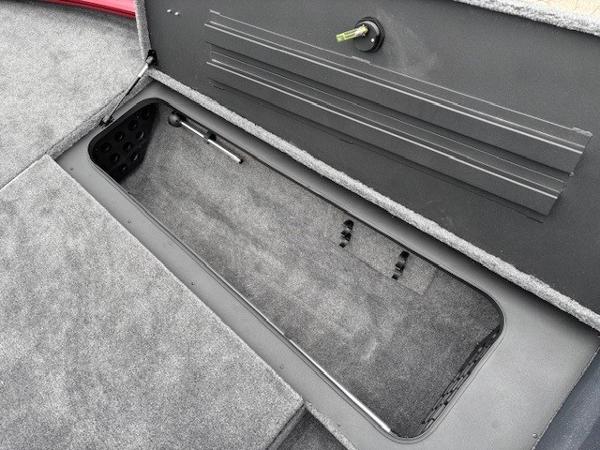 Storage compartment in 2025 Tracker Savage 215 boat, featuring carpeted interior and secure latch.