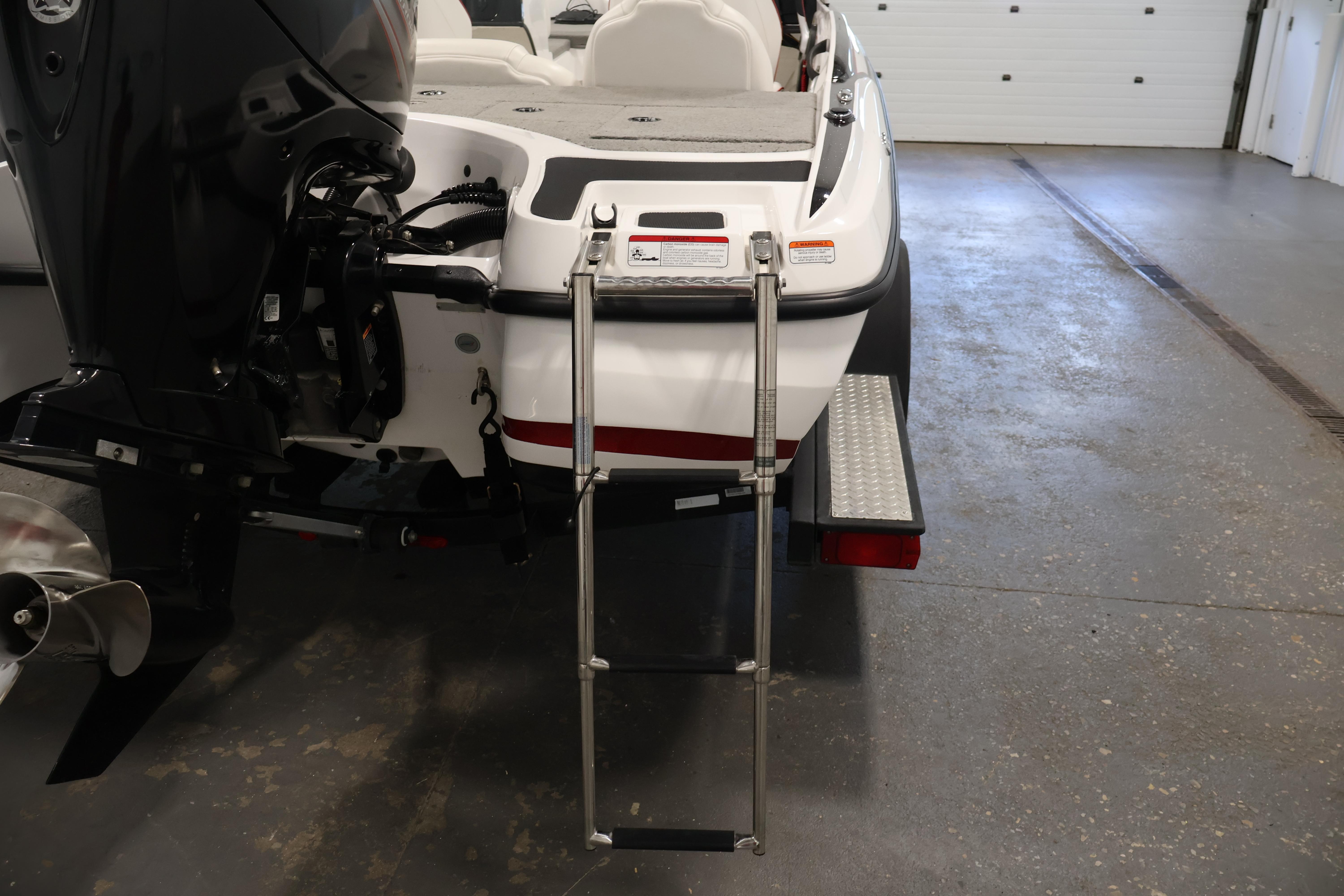 2019 Nitro Z19 Sport boat with ladder and motor in a garage setting.
