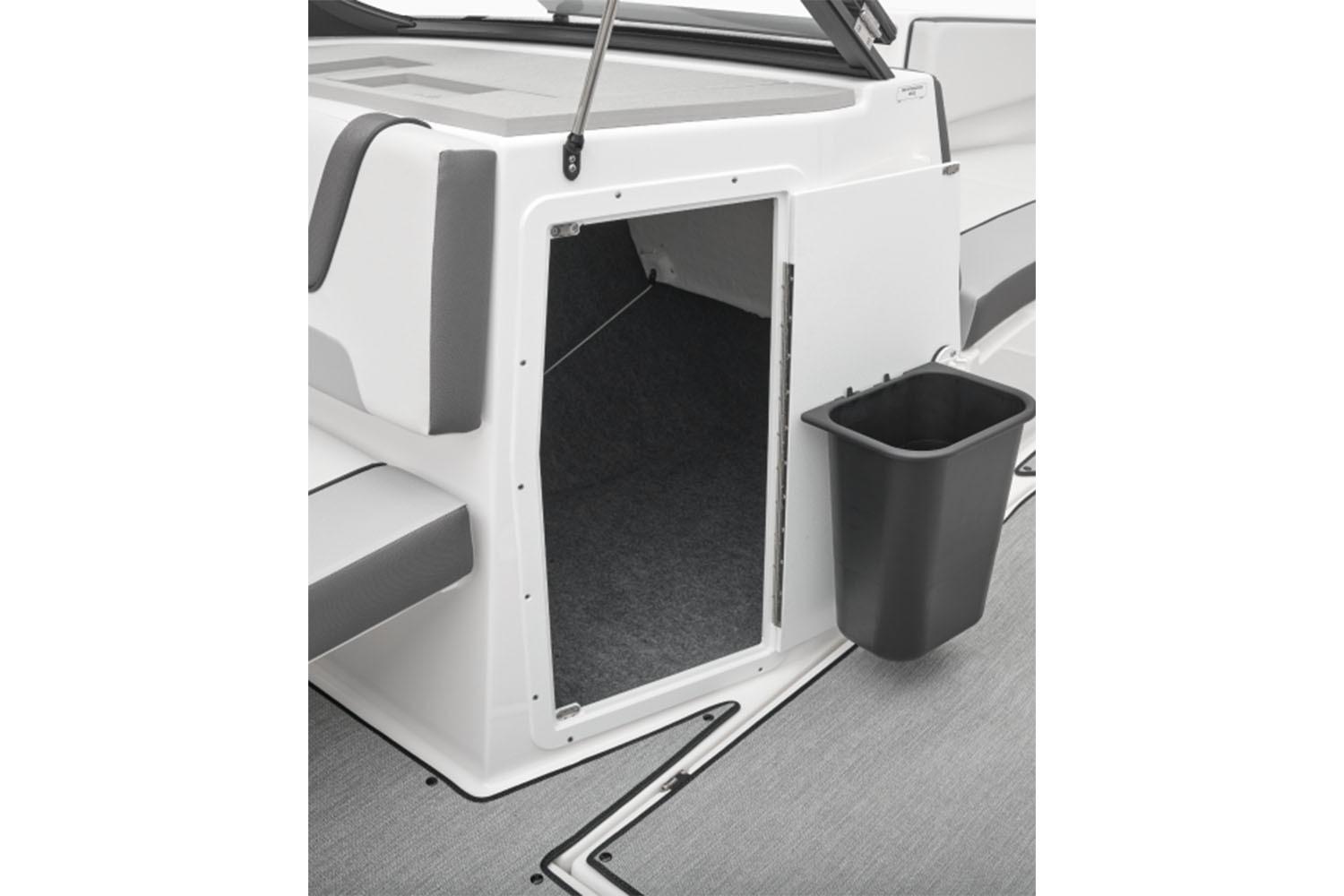 2026 Yamaha Boats AR220 interior storage compartment with gray seating and black trash bin.
