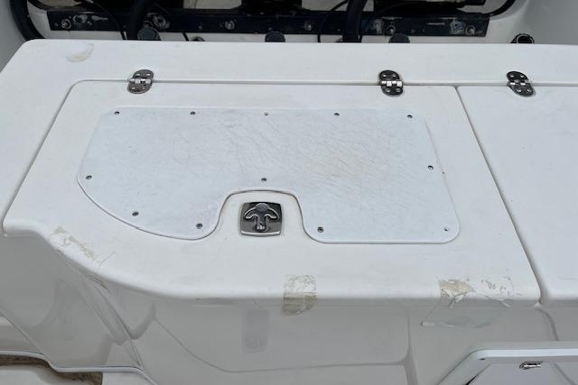 2001 Fountain 38 Center Console boat deck with storage compartment and latch.