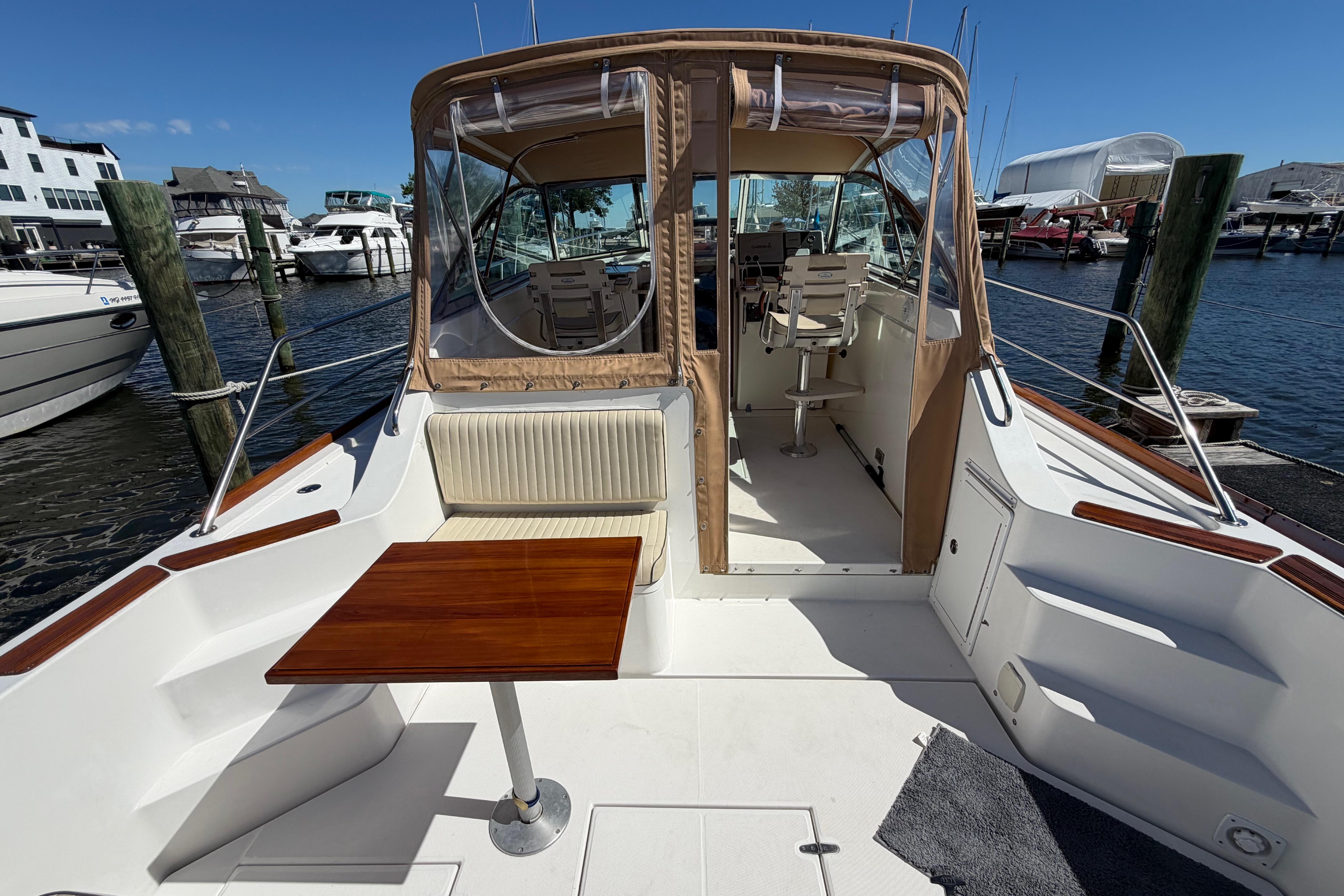 2000 Sabreline 36 Express yacht docked, featuring a spacious deck and seating area.