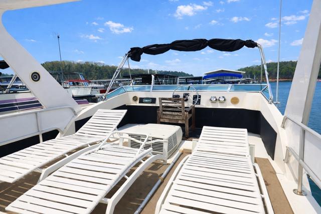 1987 Sumerset 14x64 houseboat deck with lounge chairs and scenic lake view.