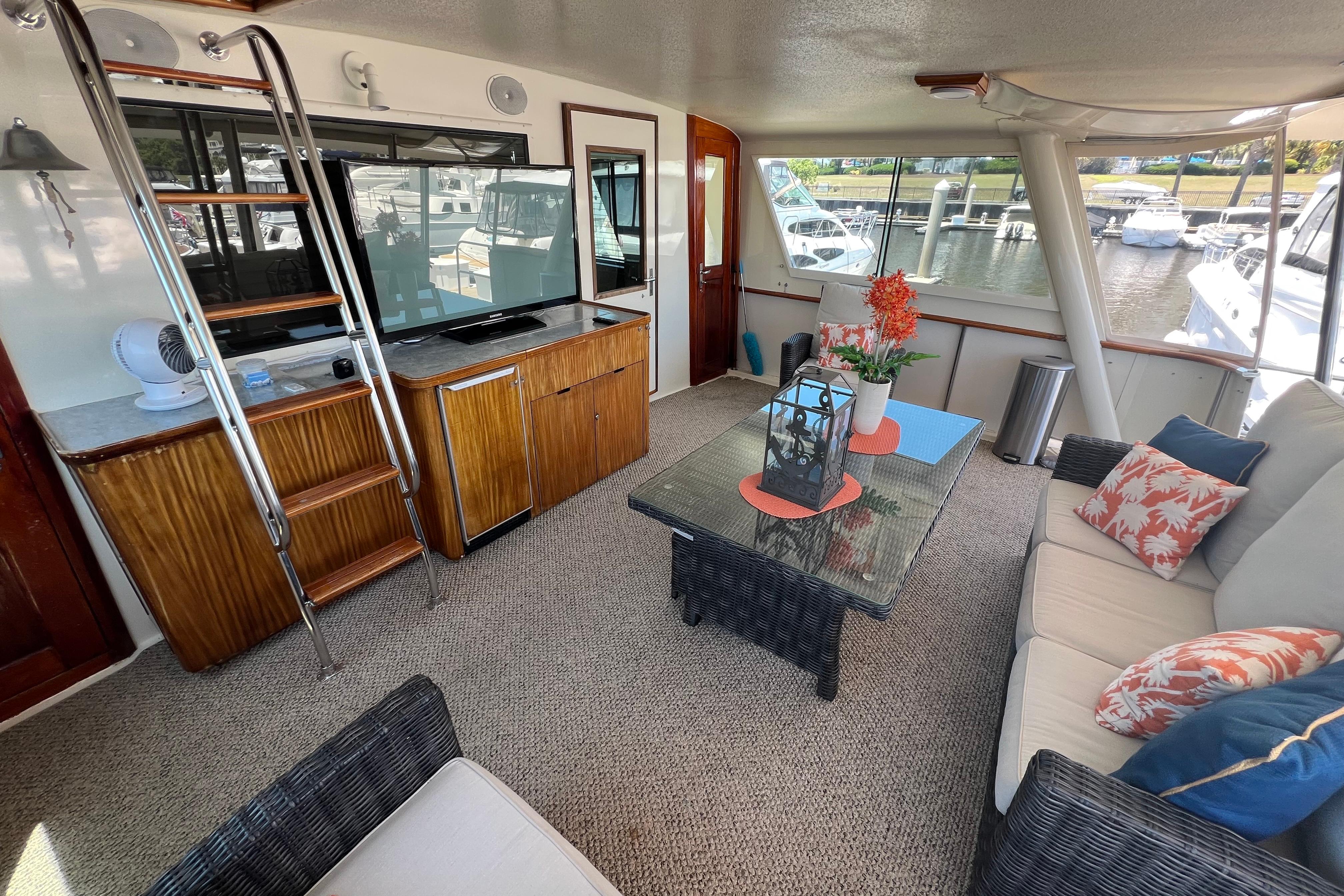 Luxurious interior of 1987 Hatteras 70 Cockpit Motor Yacht with elegant seating and decor.