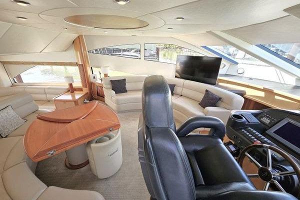 Luxurious interior of a 2005 Sunseeker Manhattan 66 yacht with plush seating and modern helm.