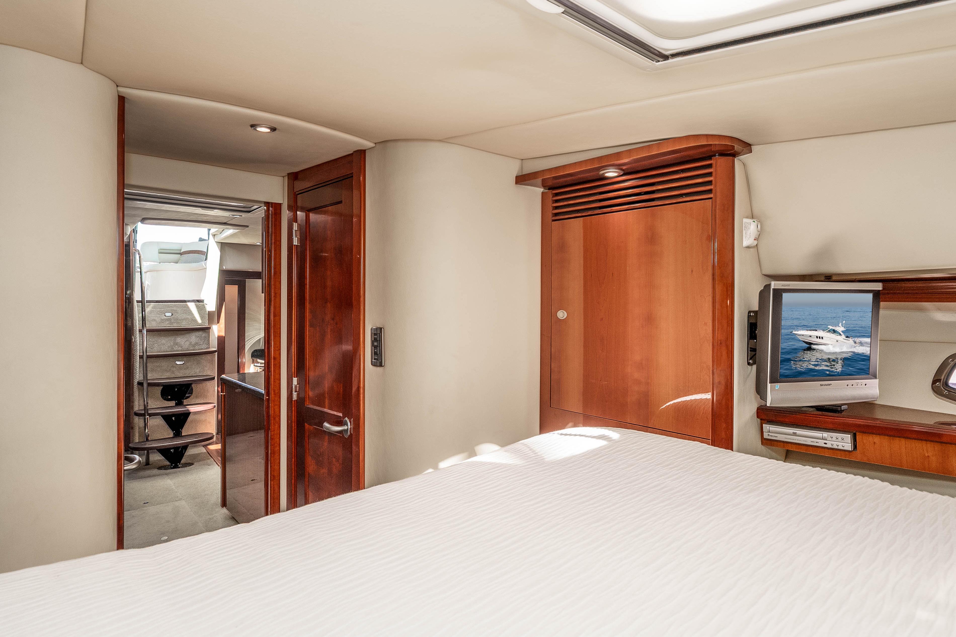 Interior of 2007 Sea Ray 48 Sundancer yacht with wood accents and TV.