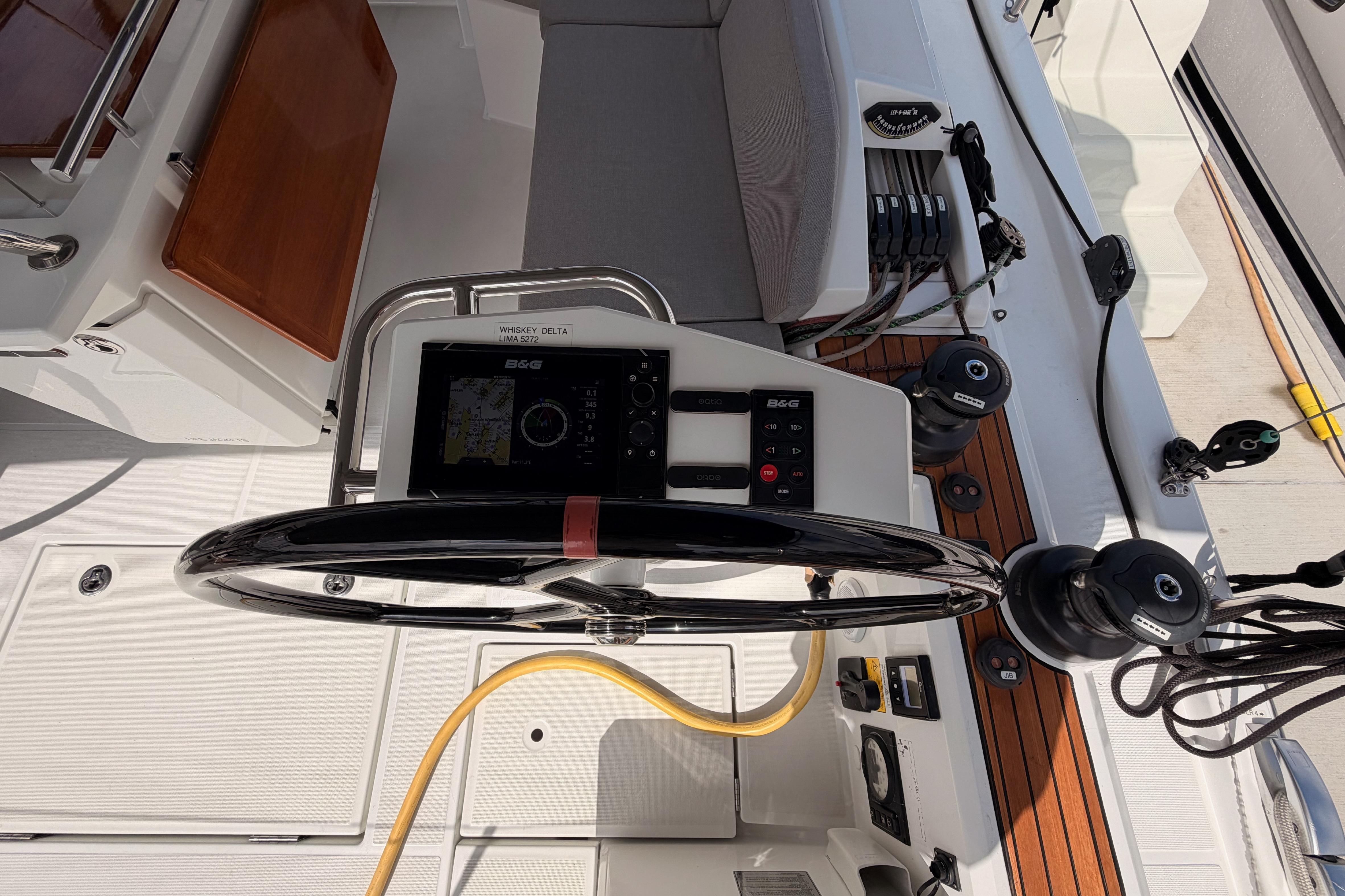 Cockpit of 2020 Beneteau Oceanis 46.1 sailboat with steering wheel and navigation equipment.