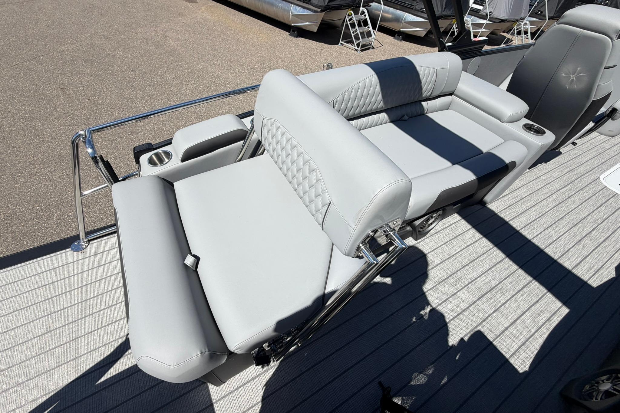 Luxurious seating on 2026 Avalon Catalina Quad Lounge Shift pontoon boat, featuring elegant gray upholstery.