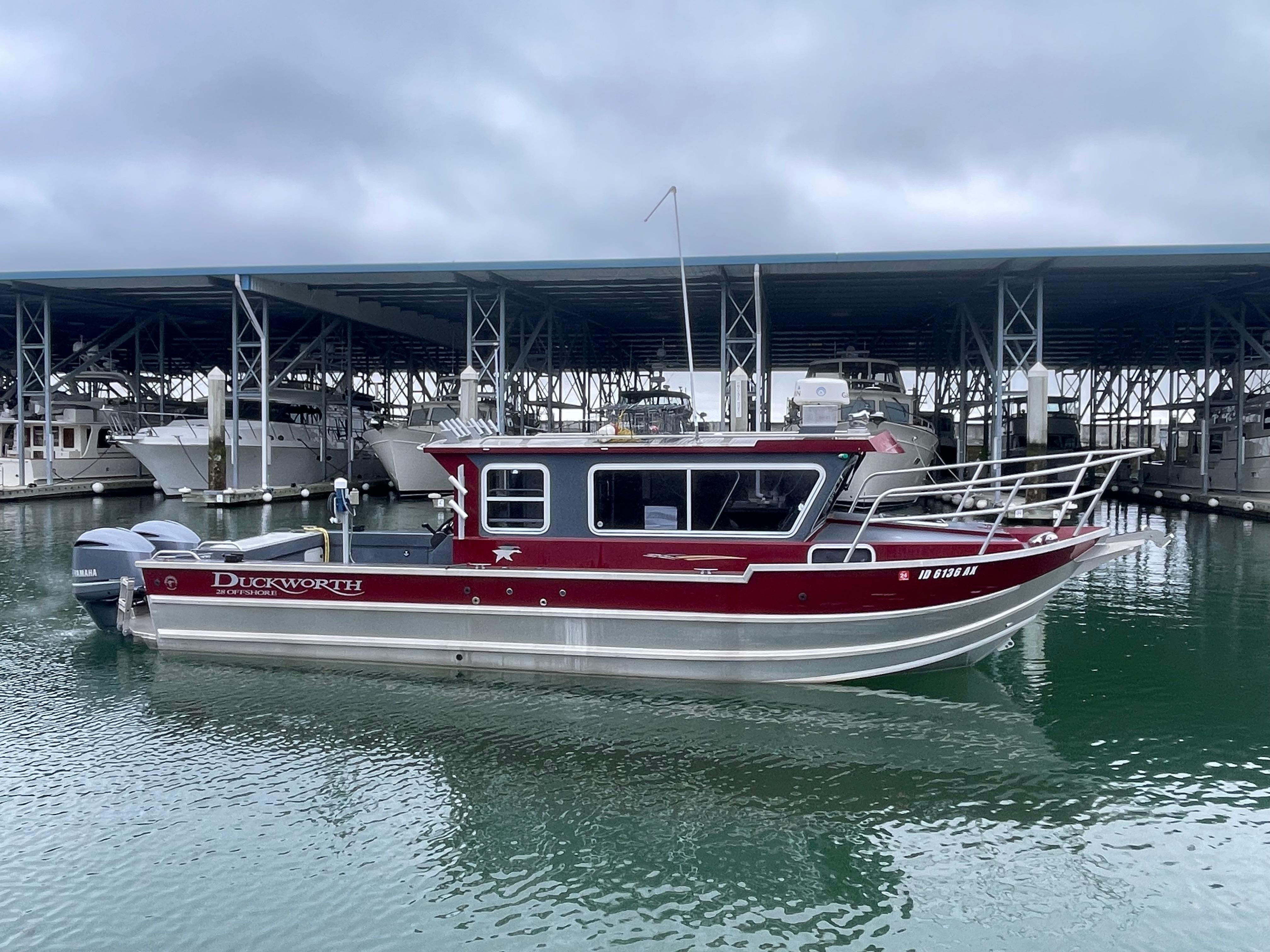 2018 Duckworth 28 Offshore boat docked in marina, overcast sky.