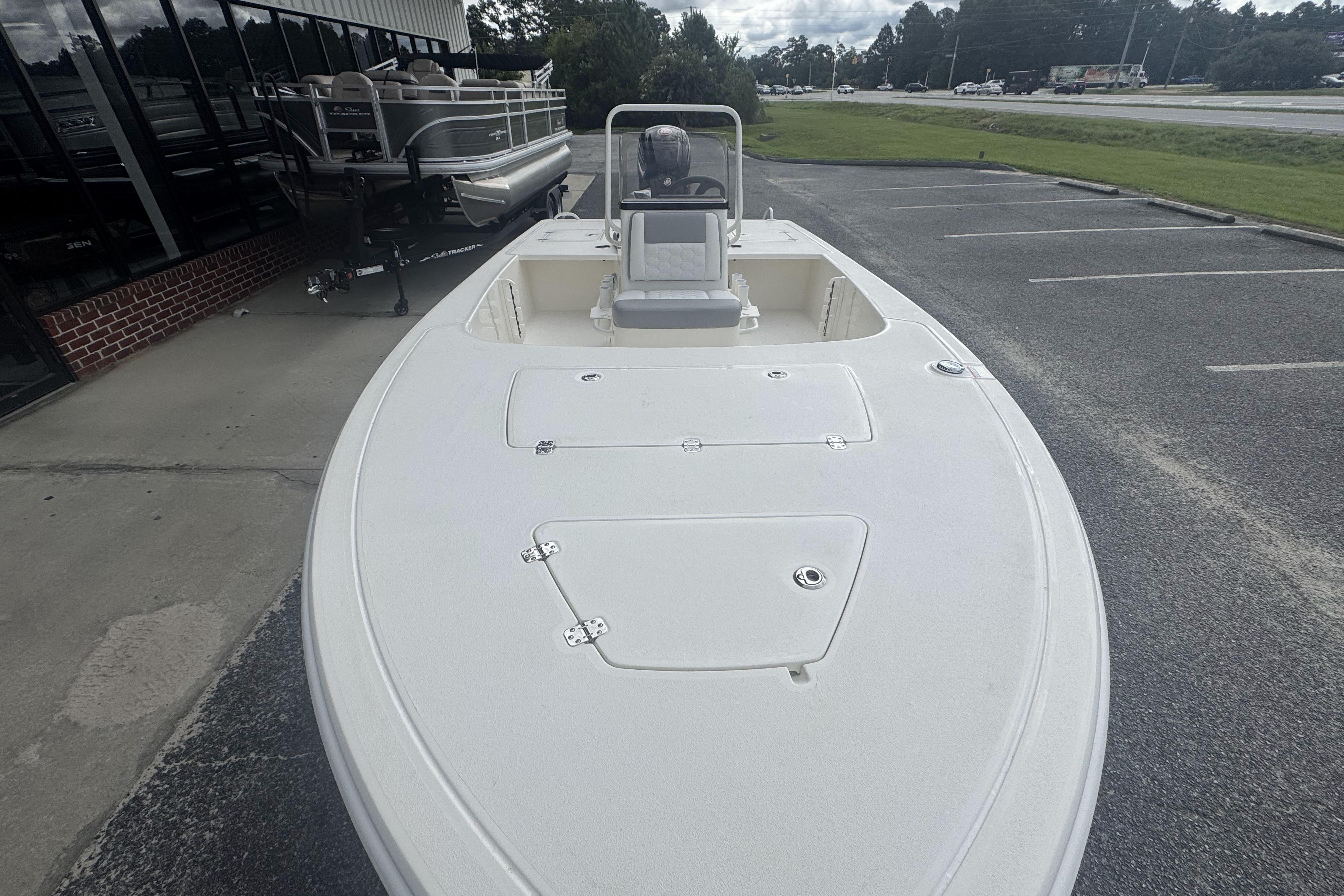 2026 Mako 18 Pro Skiff boat displayed in a parking lot, showcasing its sleek design.