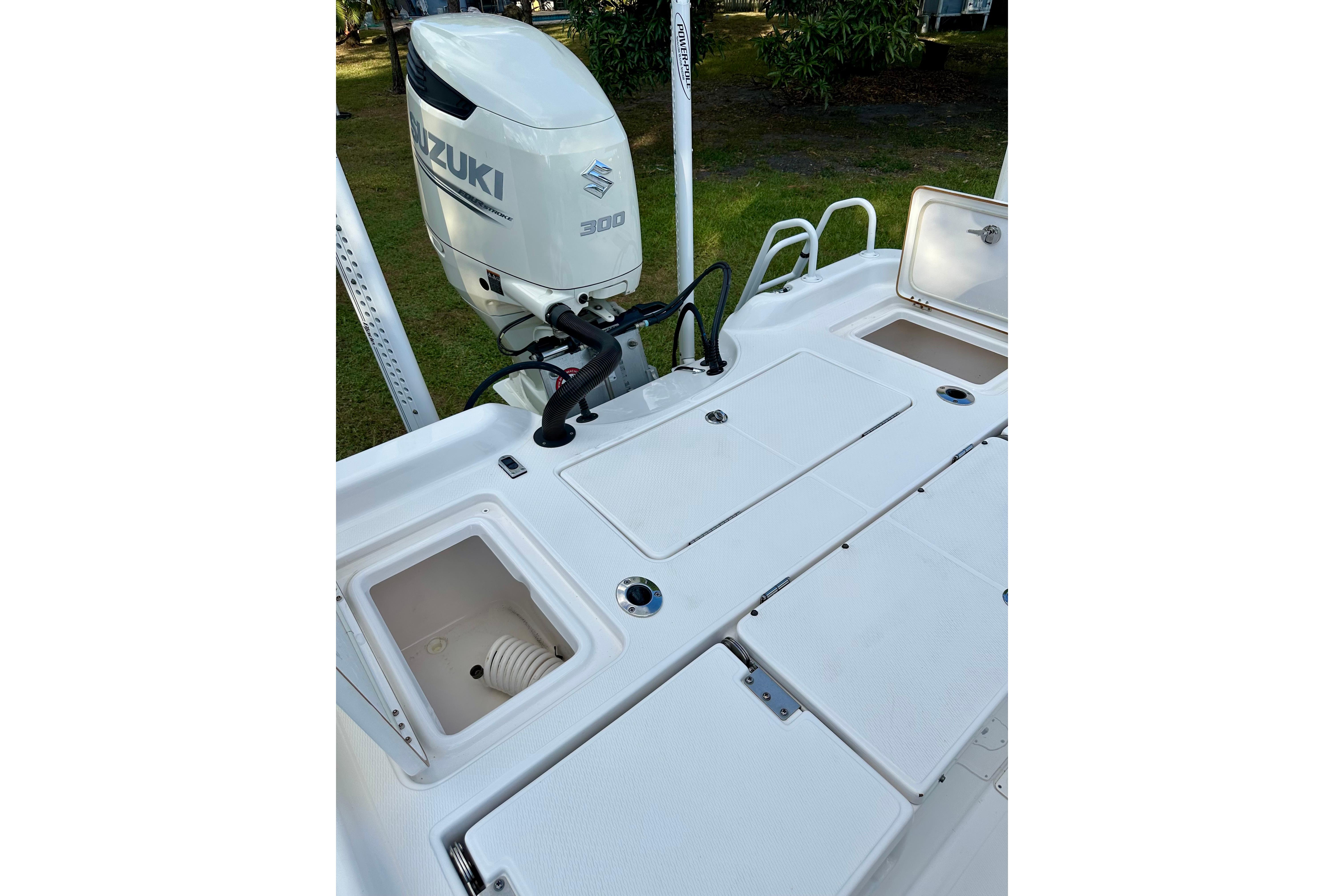 2017 Blue Wave 2400 PureBay boat with Suzuki 300 outboard motor, open storage compartments.