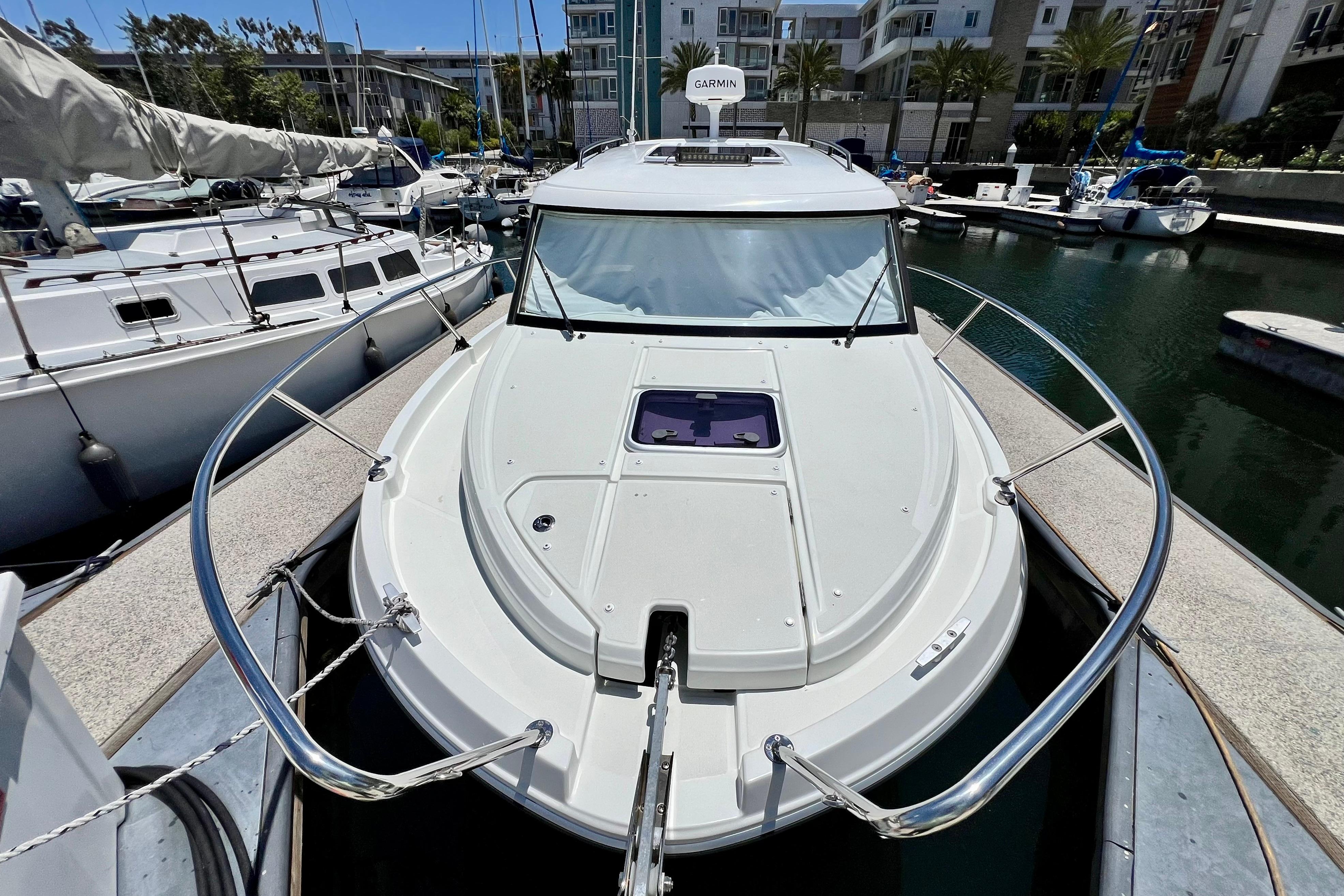 2023 Beneteau Antares 8 docked in marina, showcasing sleek design and modern features.