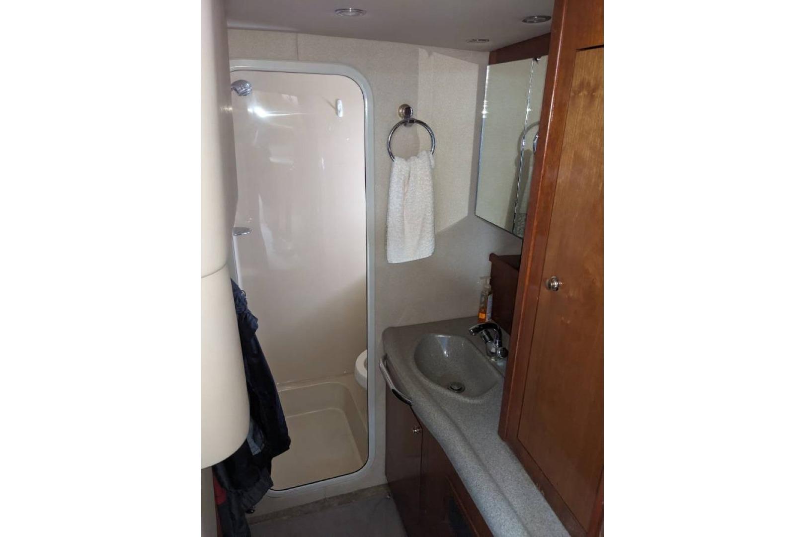 Bathroom interior of 2003 Cruisers 3970 yacht with shower and sink.