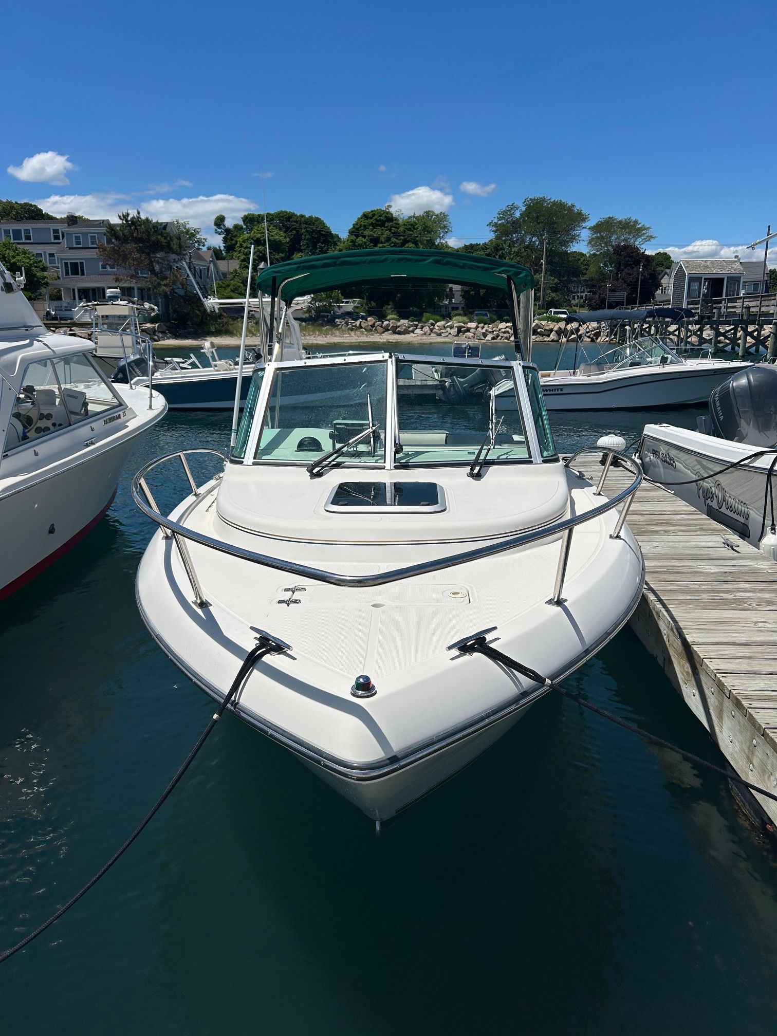 1999 Pursuit Denali boat docked on a sunny day.
