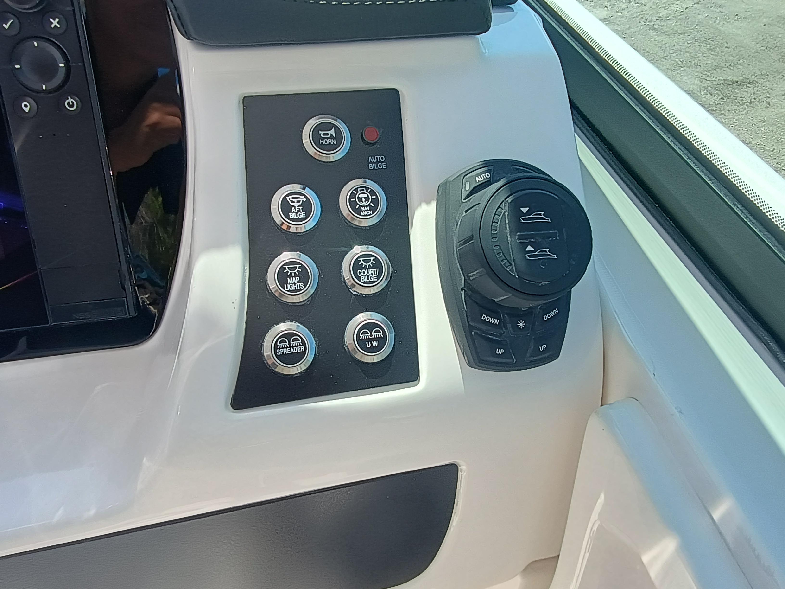 Control panel of 2025 Robalo R257 Dual Console boat with buttons and dials.