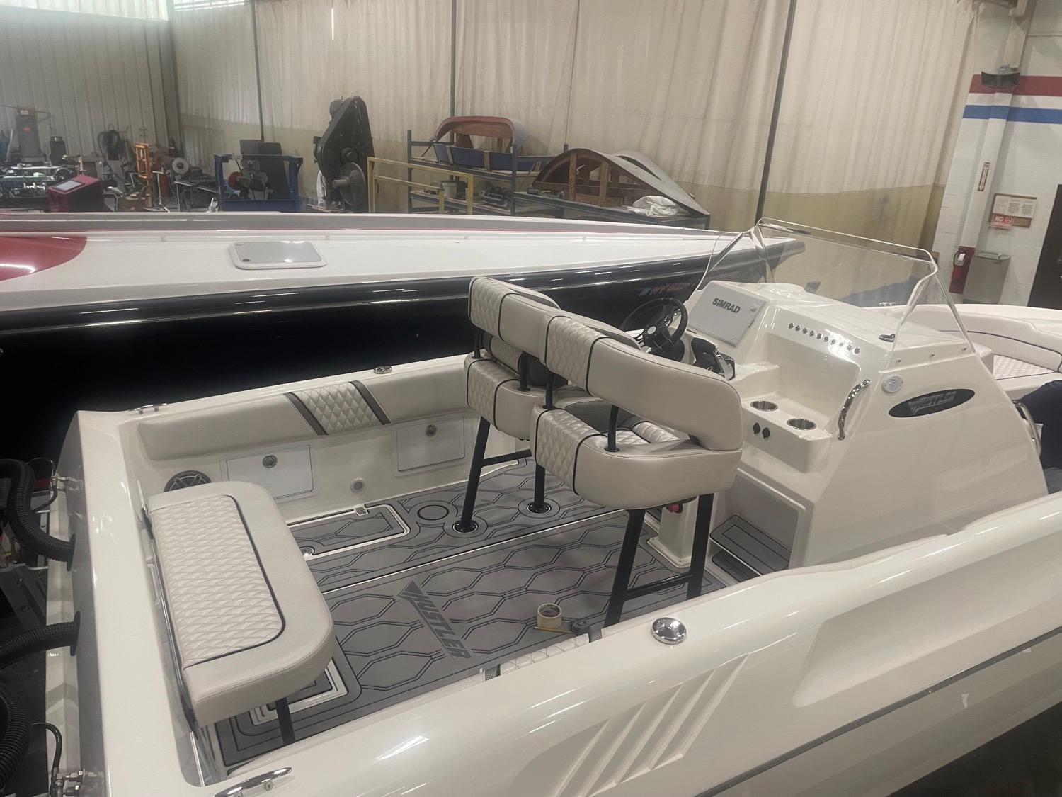 2025 Hustler 25 C3 Speedfish boat interior in a showroom.