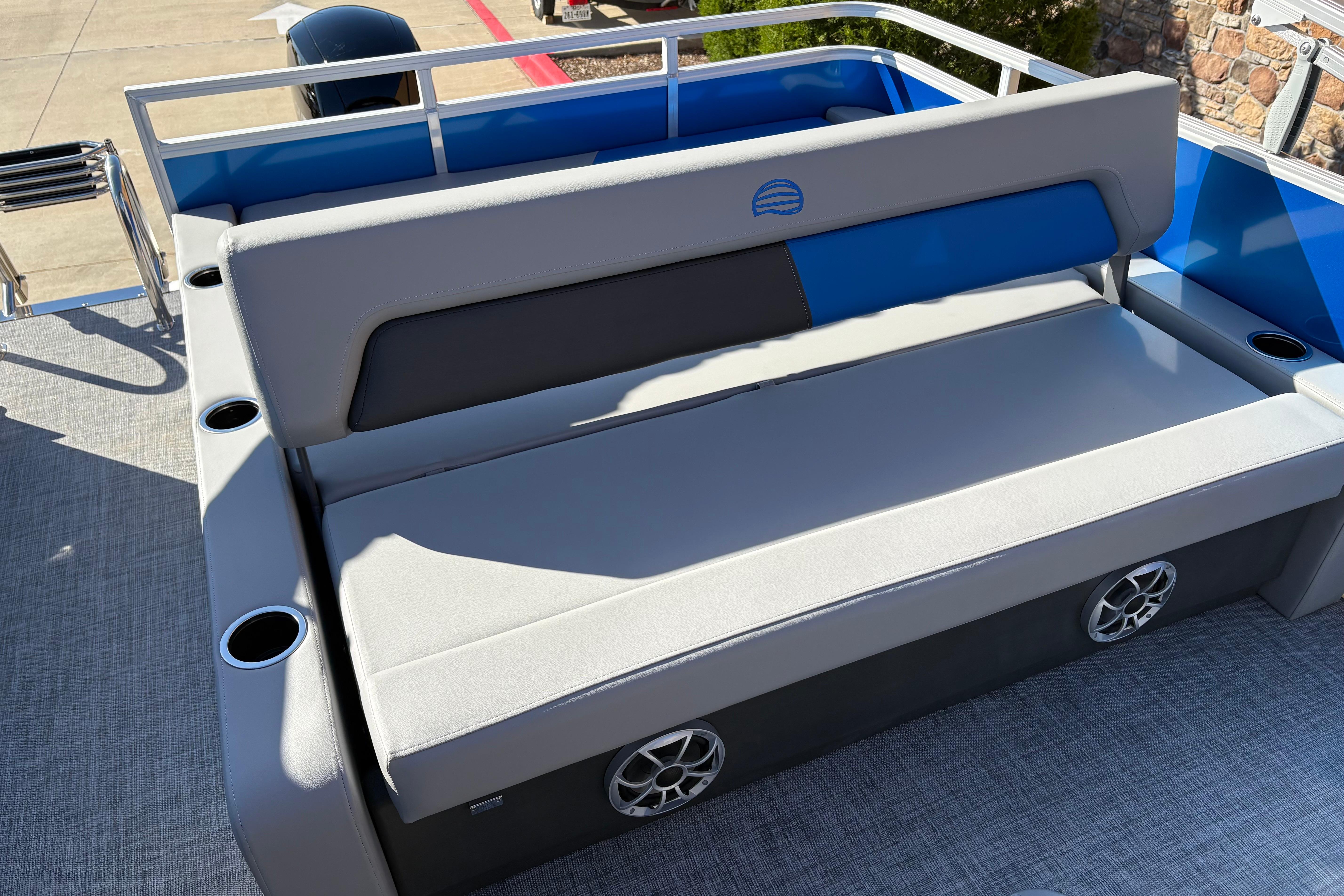2026 Sun Tracker Party Barge 22 RF XP3 seating area with cup holders and speakers.