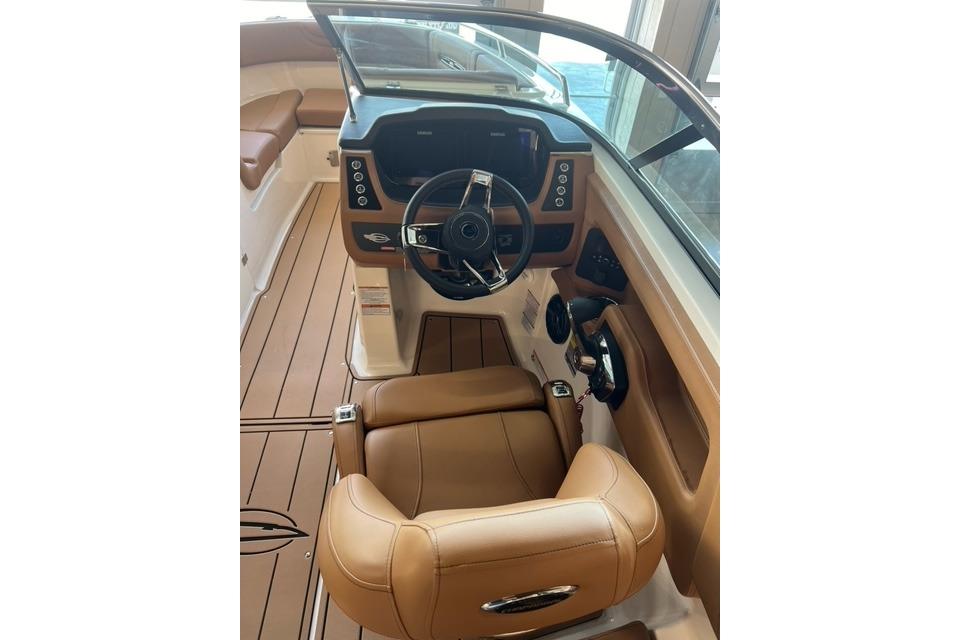 2025 Chaparral 247 SSX boat interior with tan leather seating and modern dashboard.