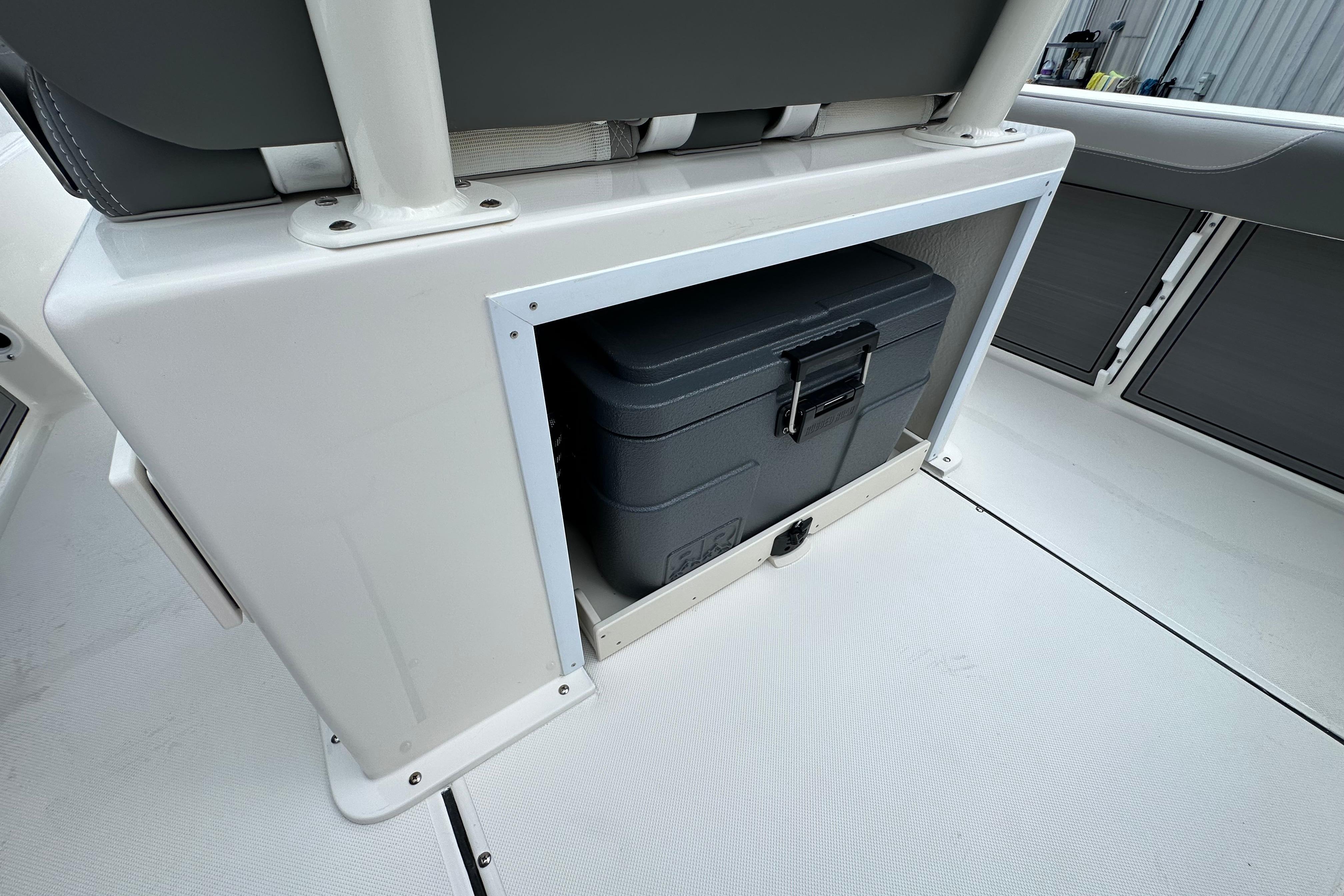 2027 Sea Born LX24 Center Console boat storage compartment with a secured cooler.