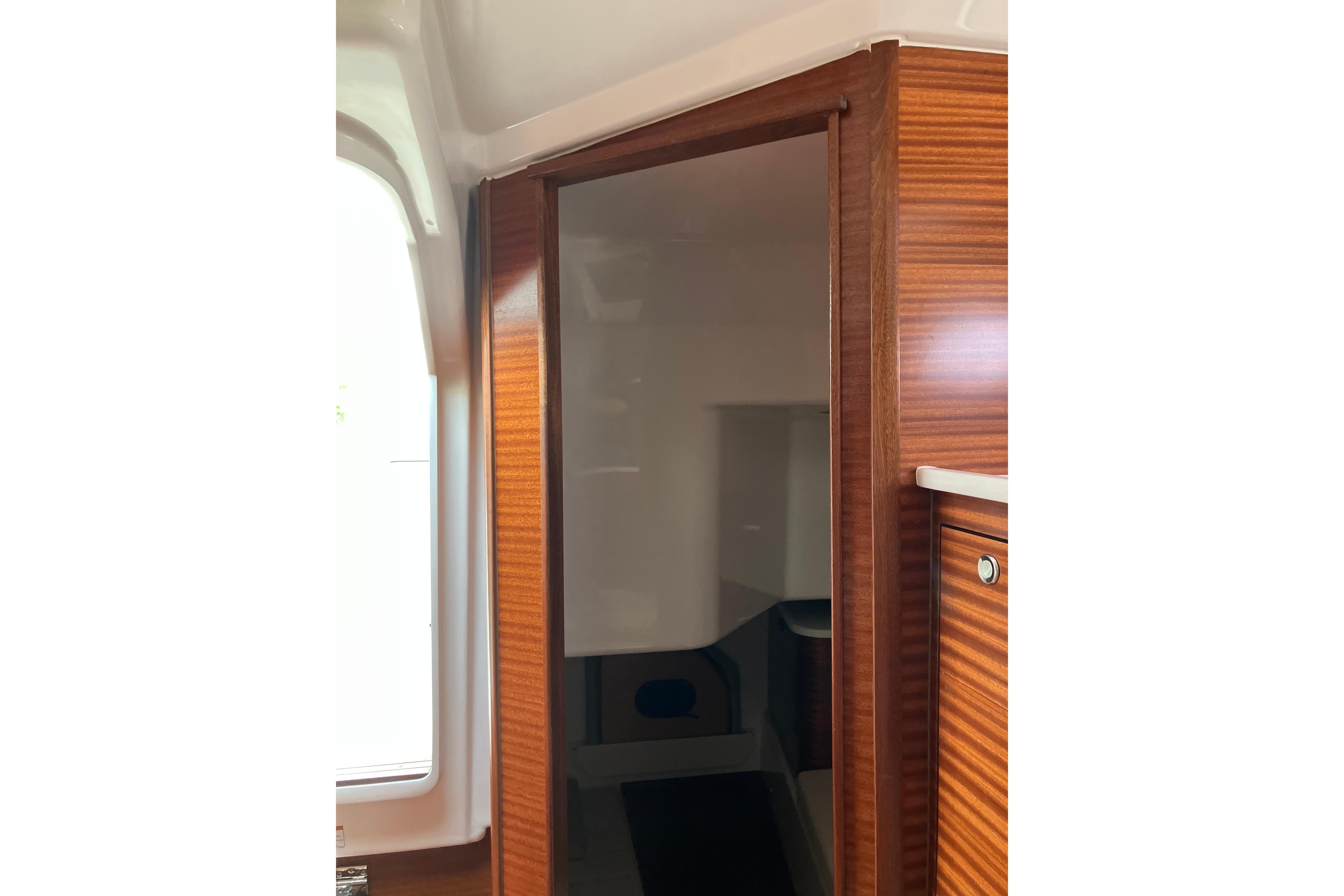 Interior view of 2025 Pursuit OS 405 Offshore boat with wooden cabinetry.