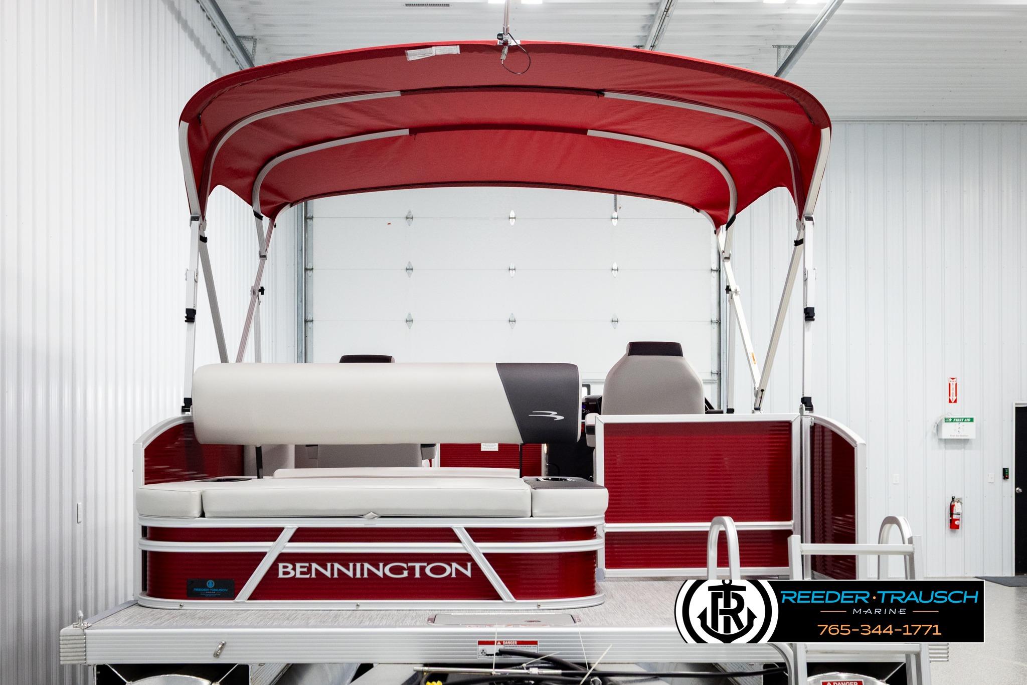 2026 Bennington SSBSF pontoon boat with red canopy in showroom.
