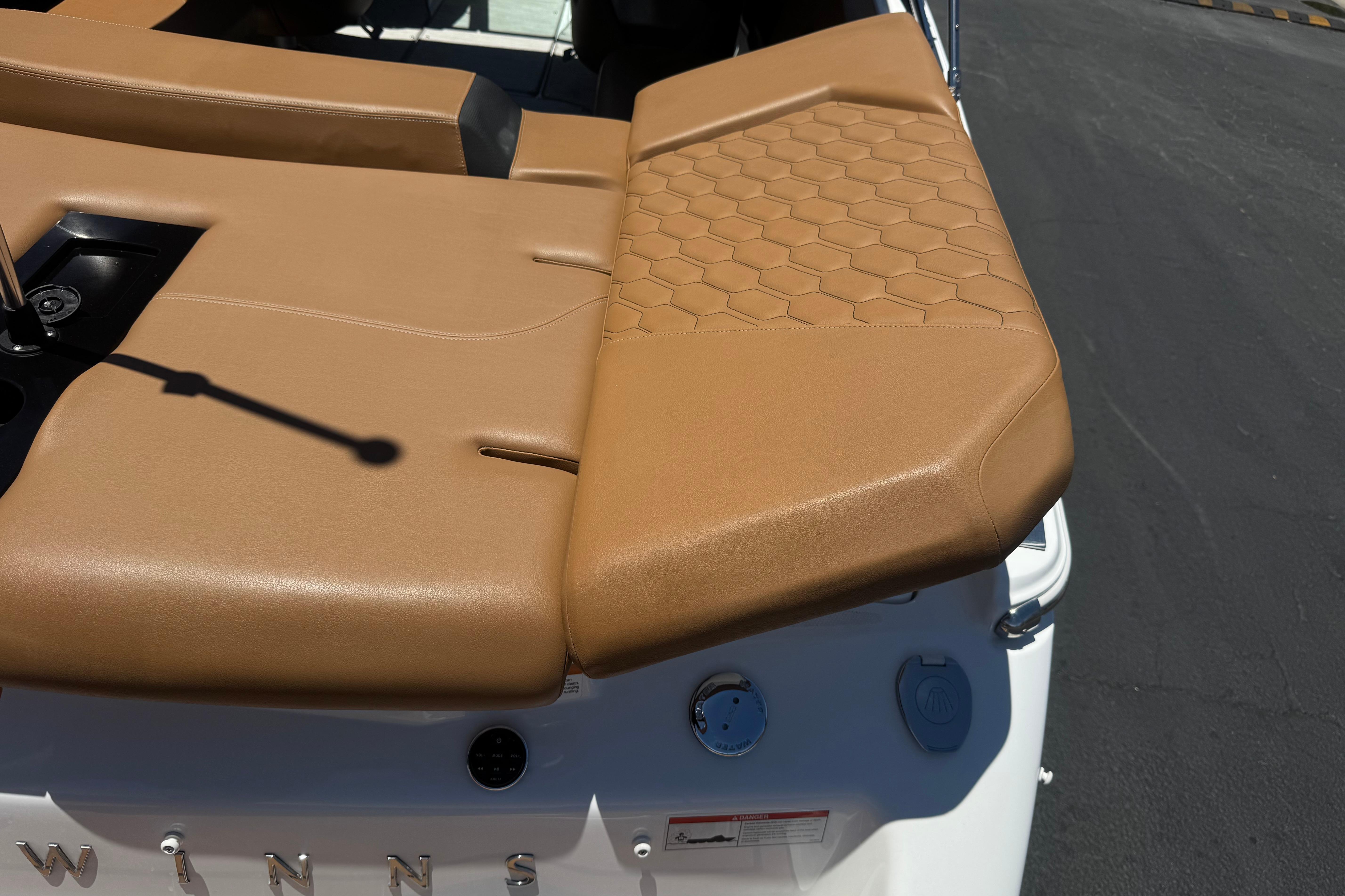 2022 Four Winns H4 boat with tan leather seating and hexagonal stitching detail.