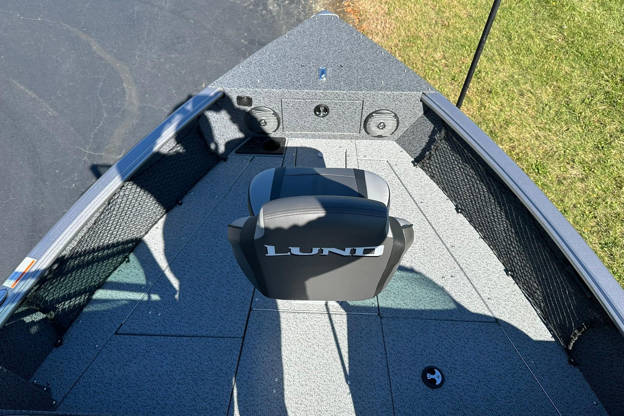 2026 Lund 1875 Impact XS Sport boat interior with seating and storage compartments.