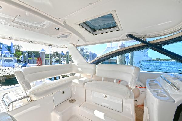 2008 Tiara Yachts 4200 Open interior with white seating and marina view.