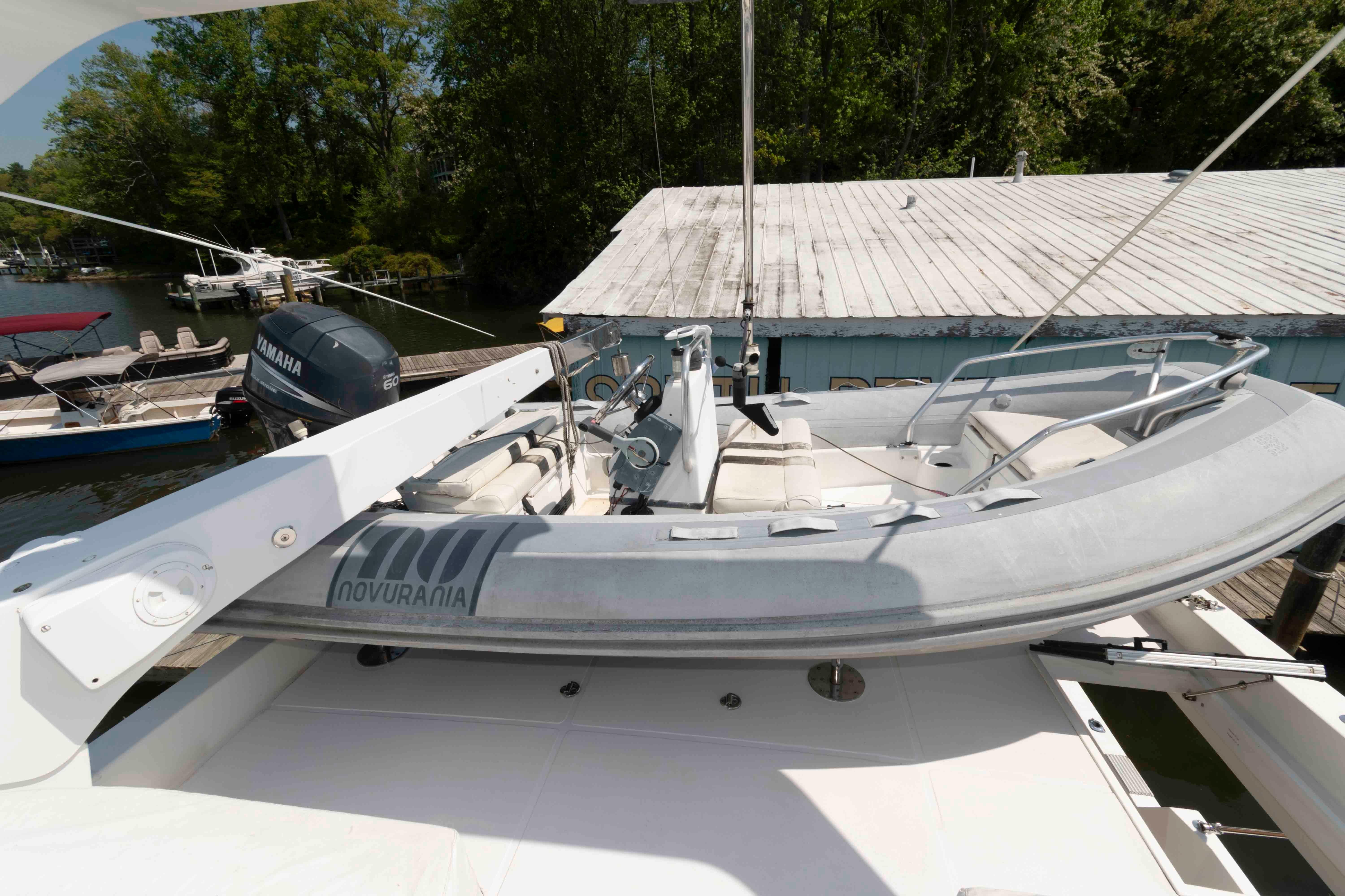1999 West Bay 58 Sonship Pilothouse MY with Novurania tender on deck.