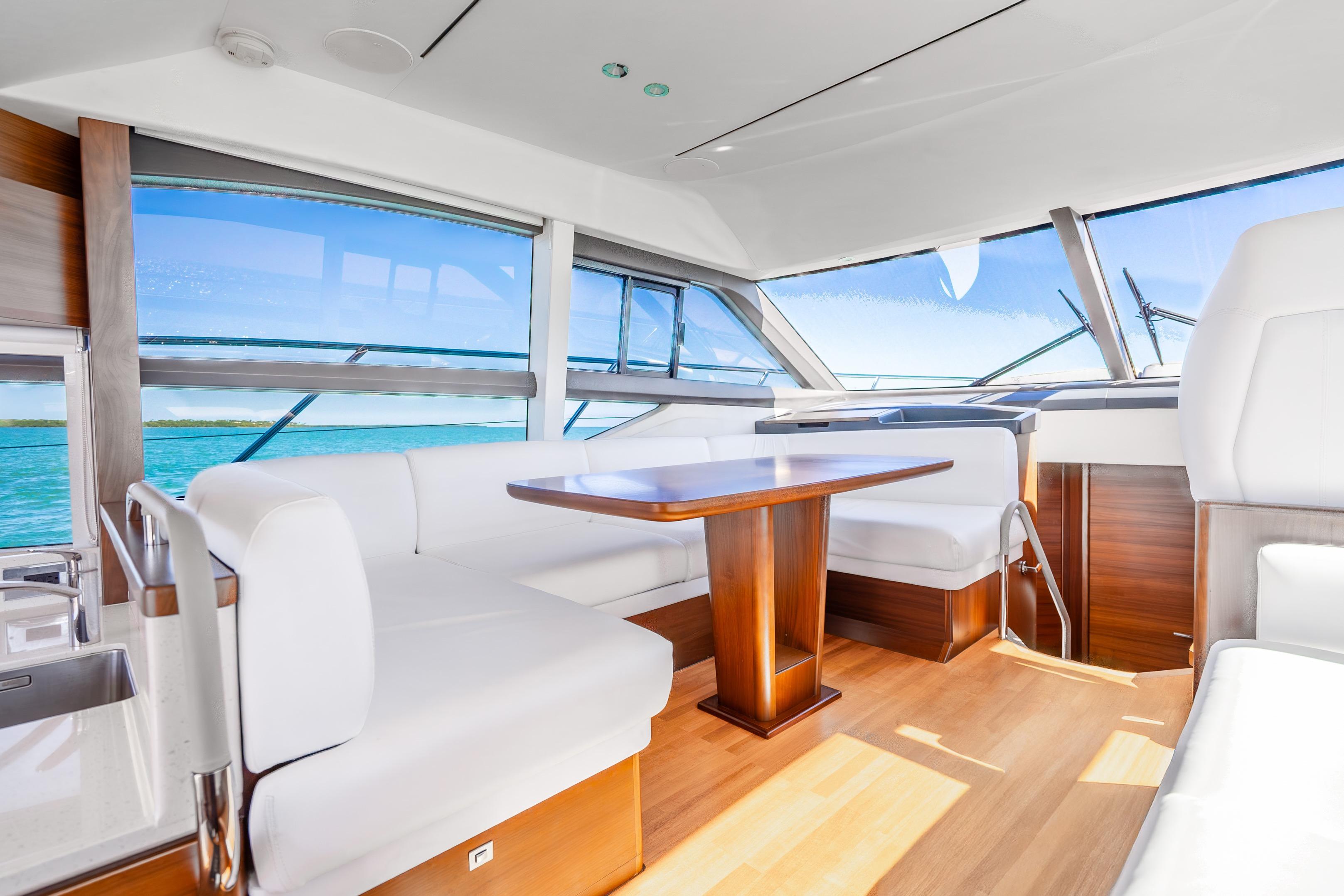 Luxurious interior of 2018 Princess F49 yacht with elegant seating and panoramic windows.