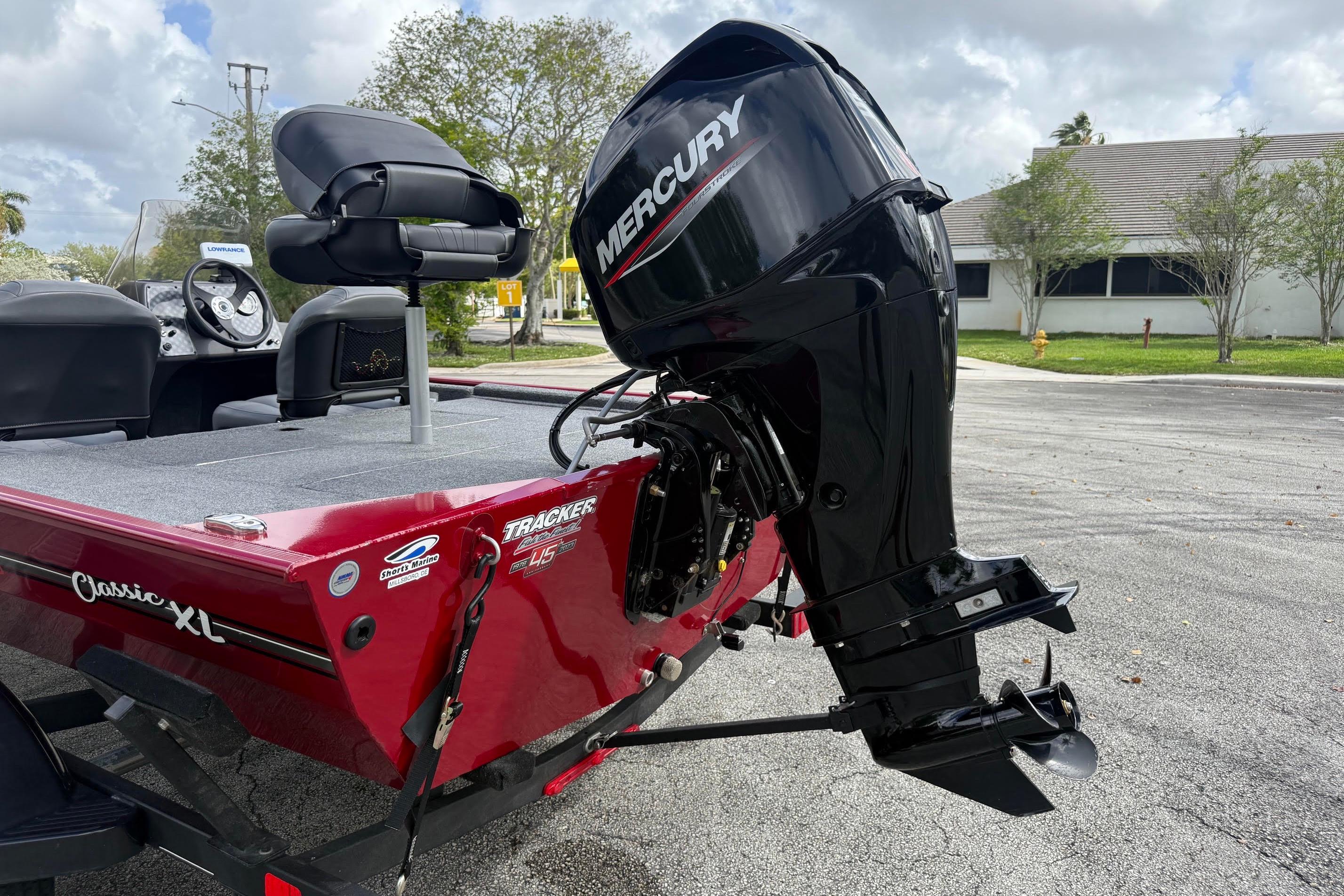 2023 Bass Tracker III Classic boat with Mercury outboard motor, parked outdoors.