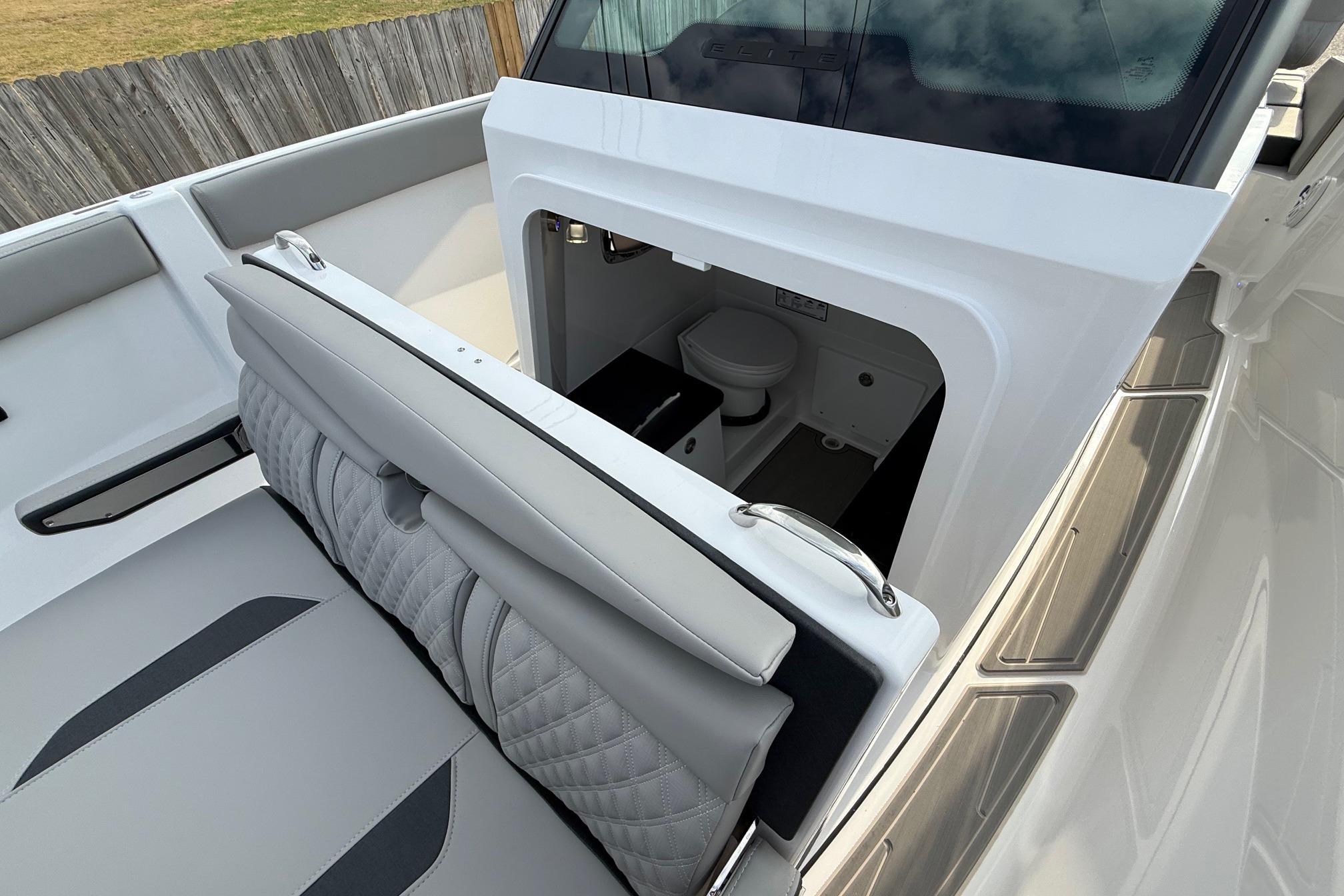 2026 Monterey Elite 25 OB boat interior with open storage compartment and seating.