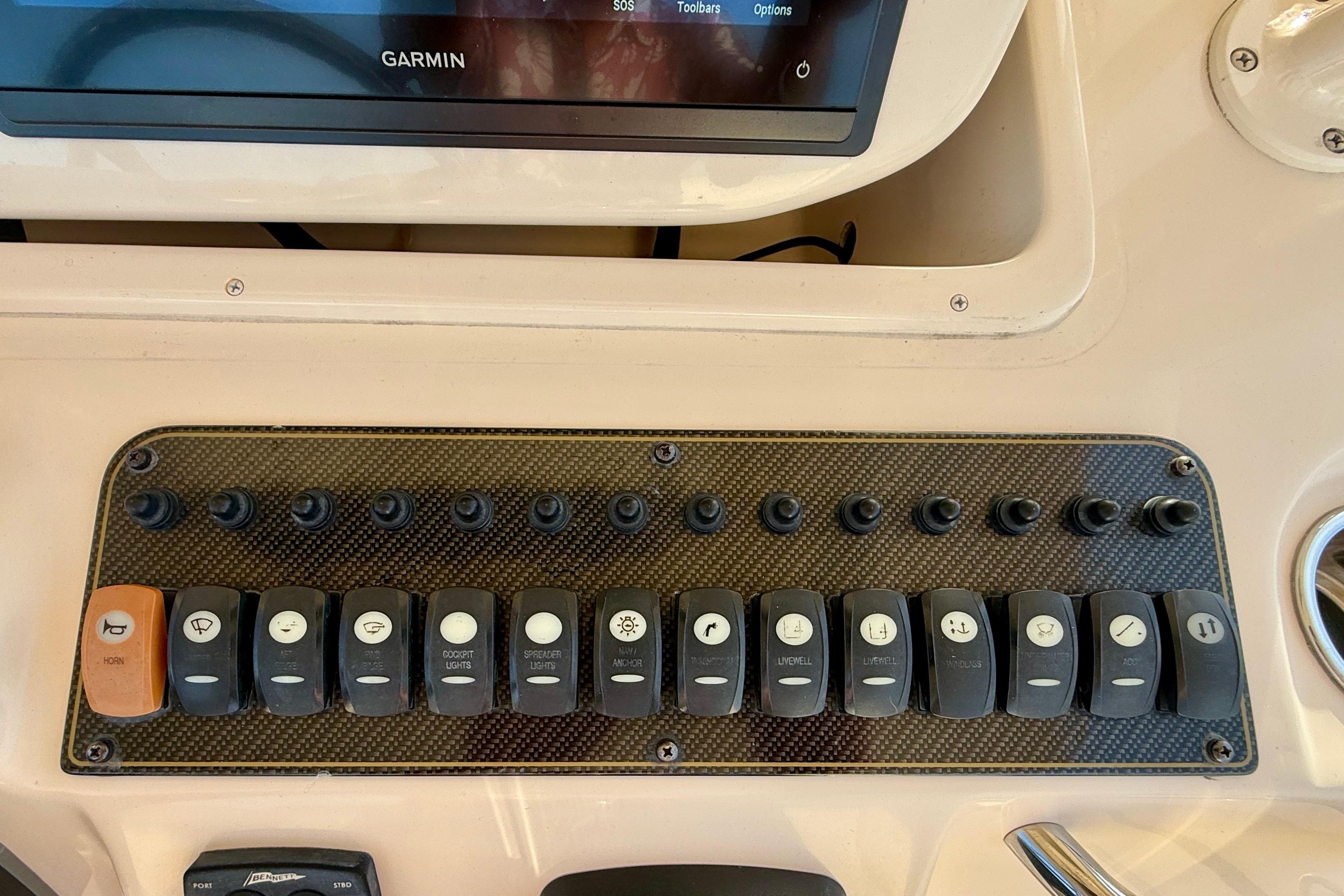 Control panel of a 2012 Grady-White Canyon 336 boat with labeled switches.