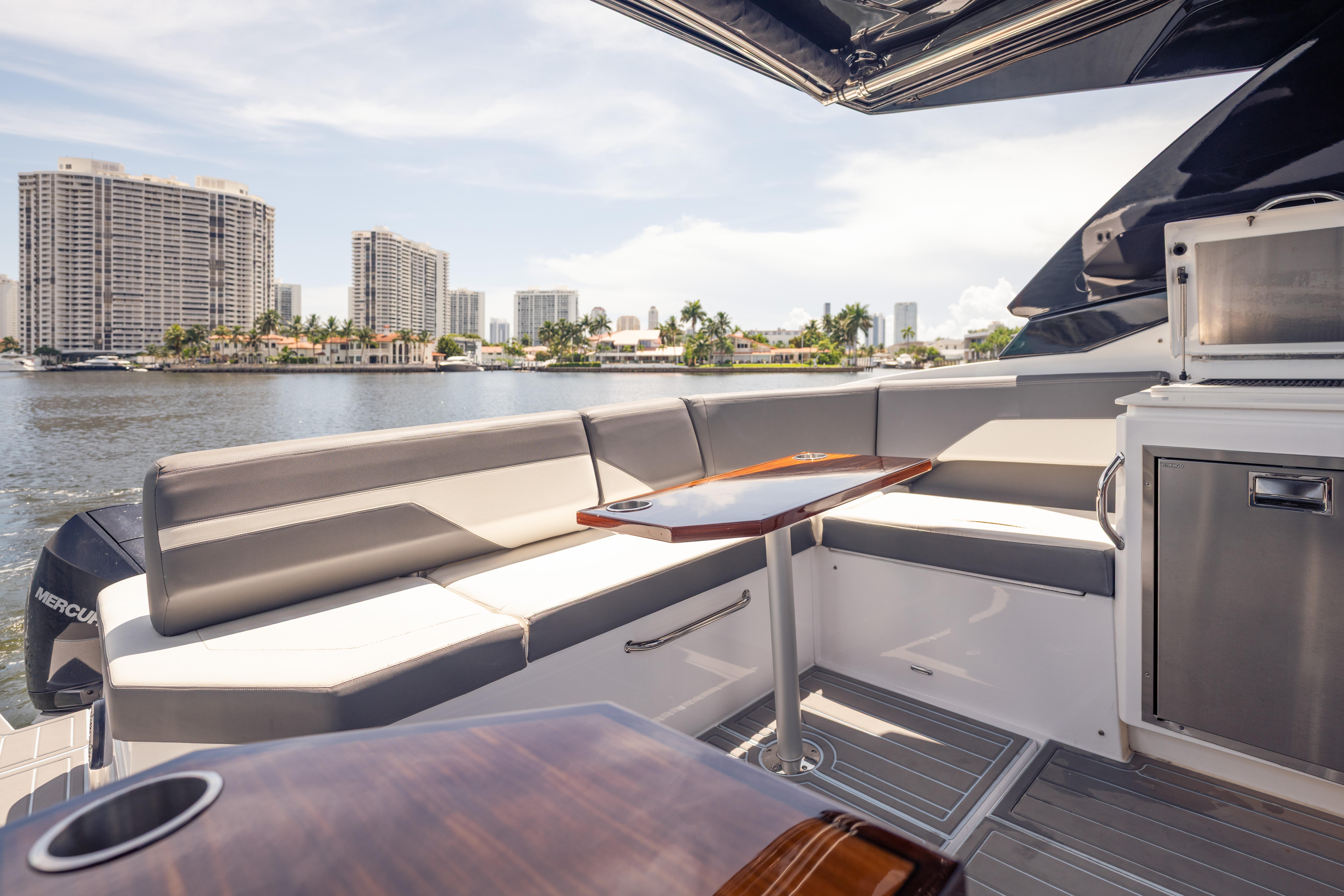 Luxurious 2021 Cruisers Yachts 38 GLS interior with waterfront cityscape view.